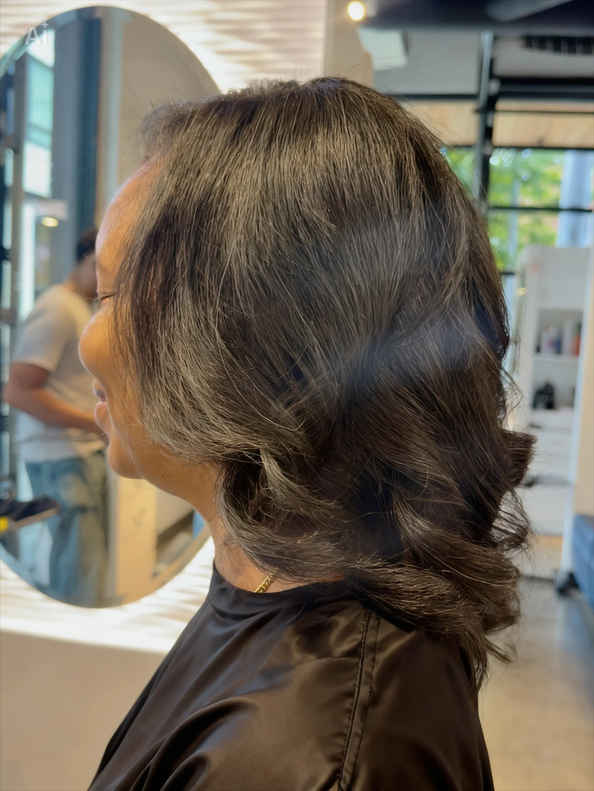 A smooth, bouncy silk press styled with soft body curls and flipped ends. 1
