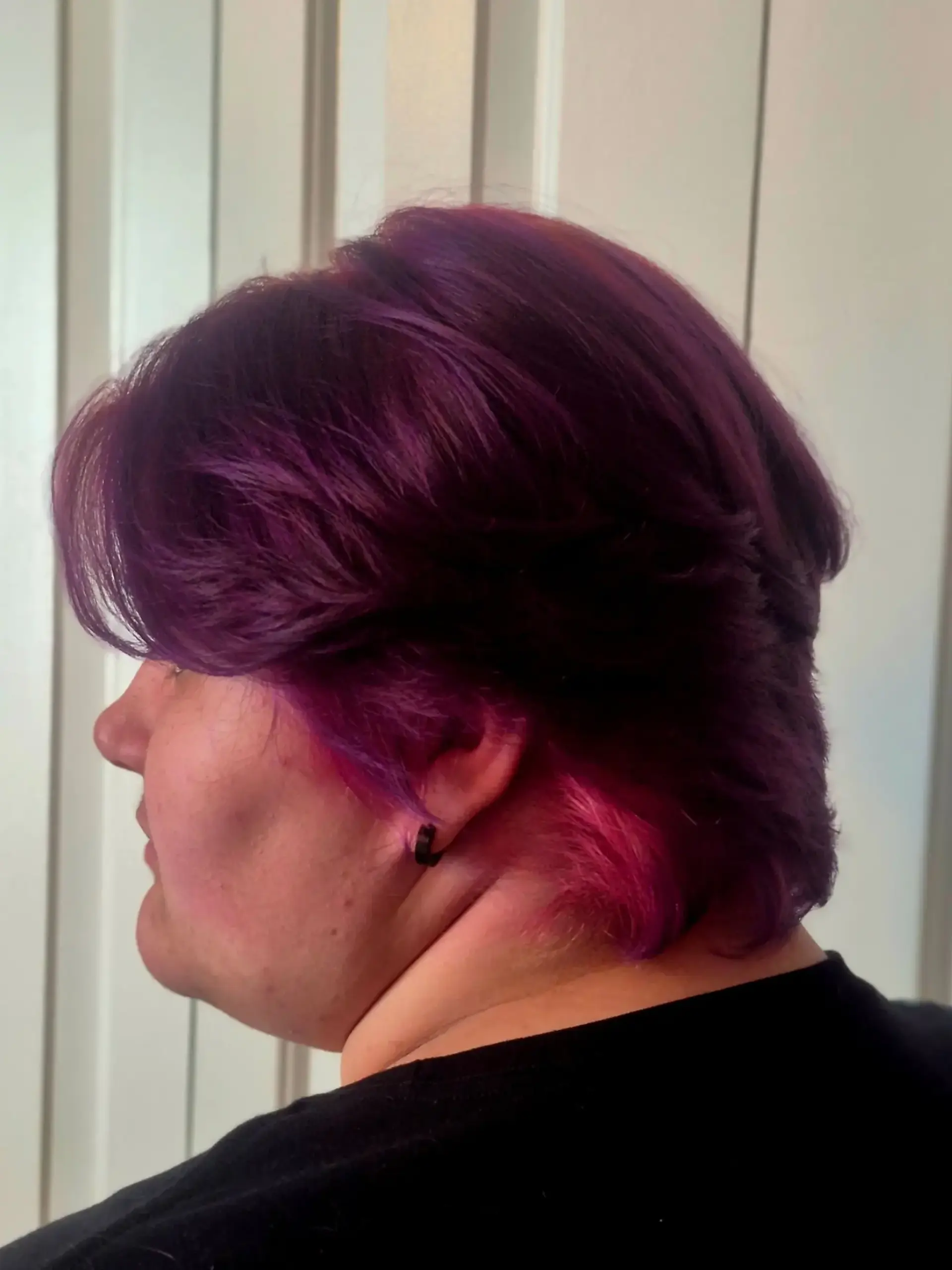 A textured, feathered short haircut dyed rich violet purple with bright pink under-color accents. 1