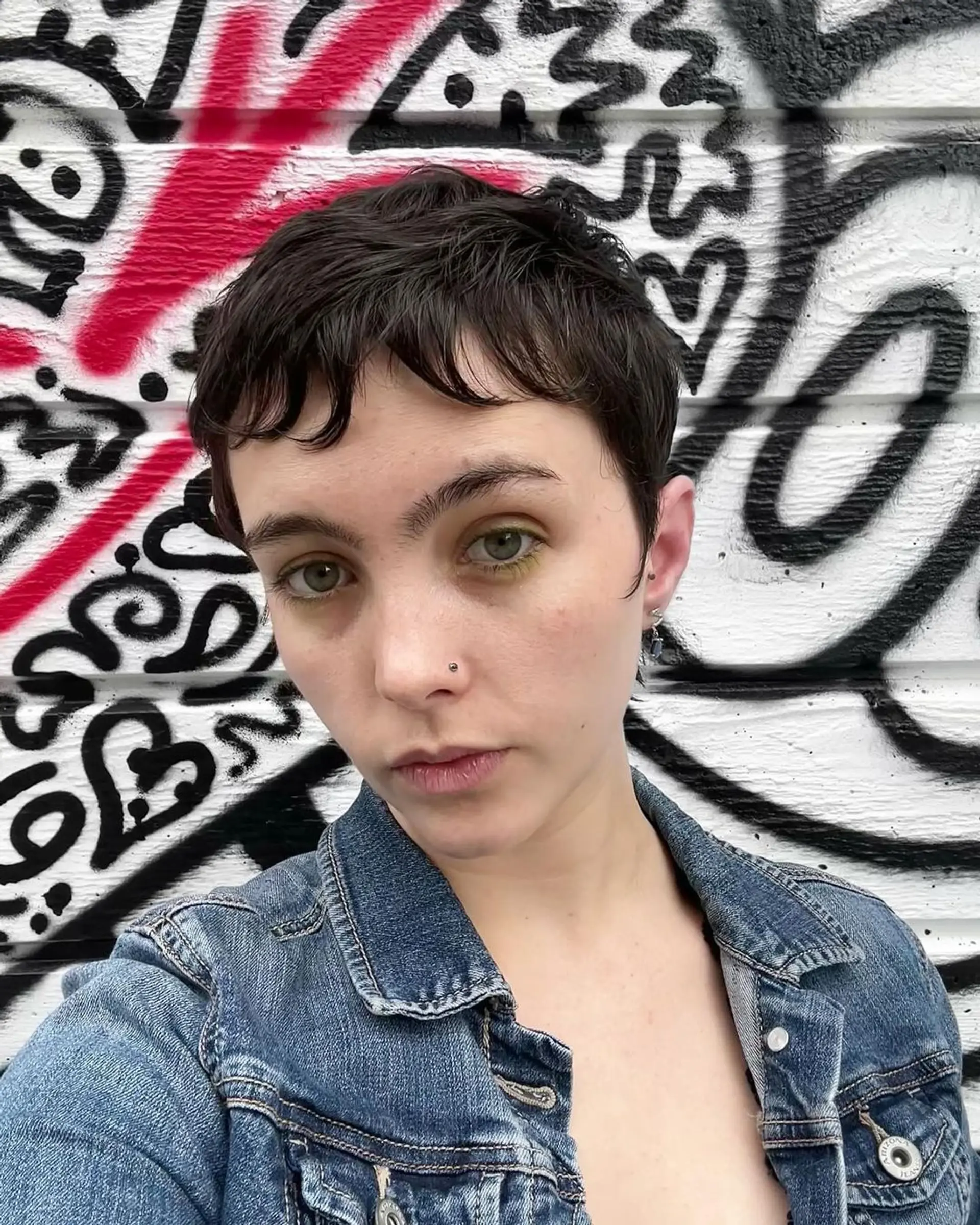 Chic pixie cut with wavy texture, styled in dark brown short hair. 1