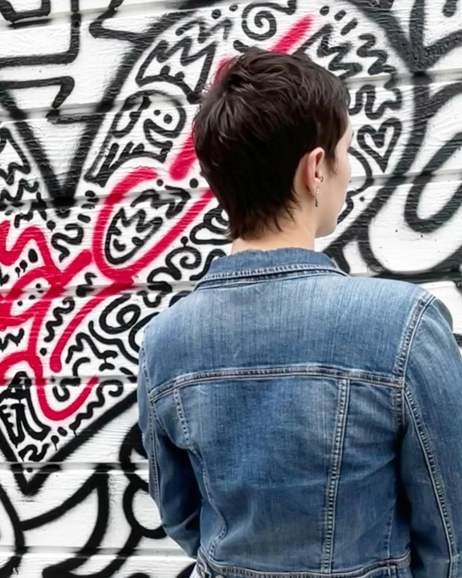 Chic pixie cut with wavy texture, styled in dark brown short hair. 2