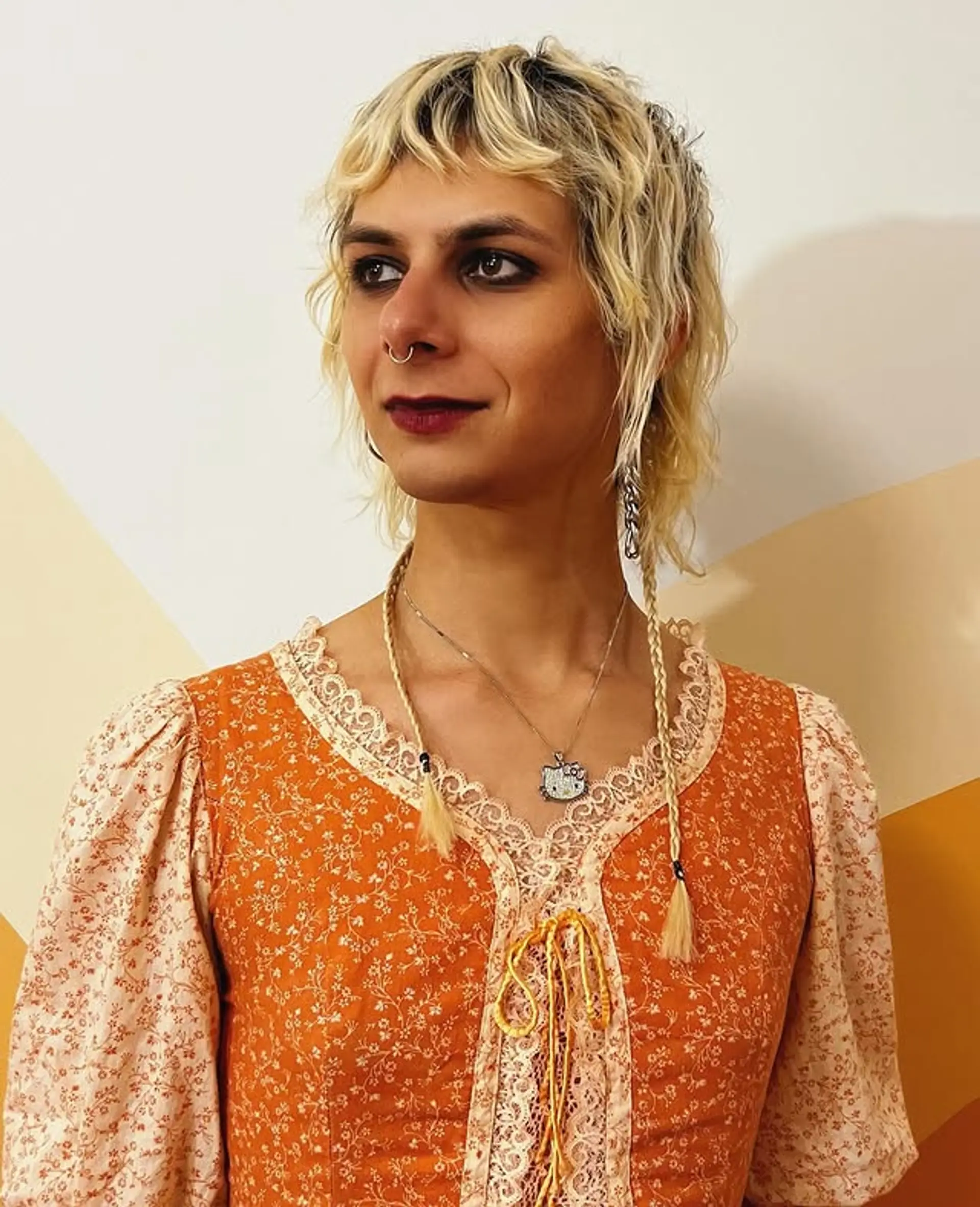 A modern shaggy mullet with textured waves and subtle face-framing braids. 1