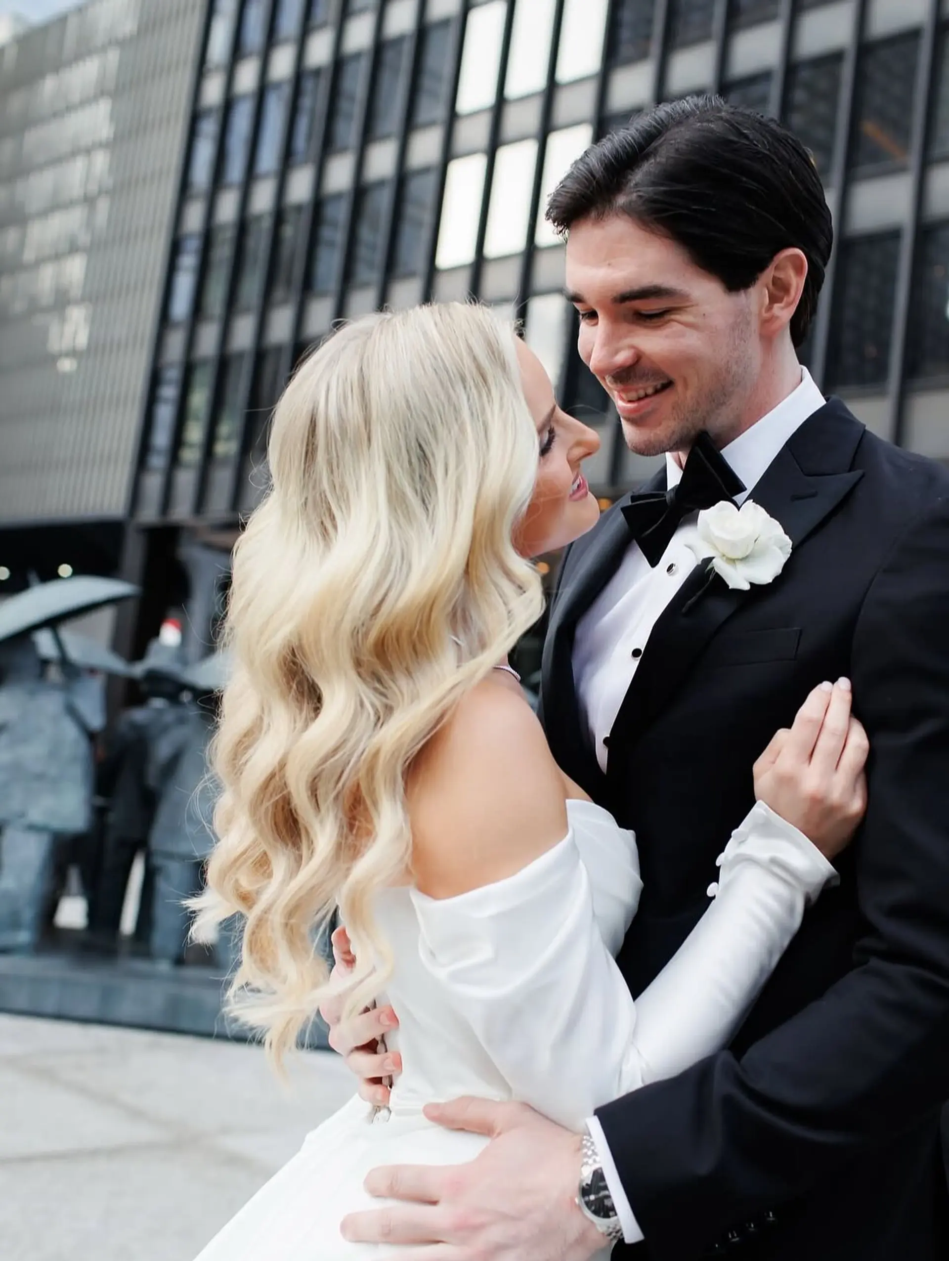 Long blonde hair styled down into polished, flowing Hollywood-style bridal waves. 1