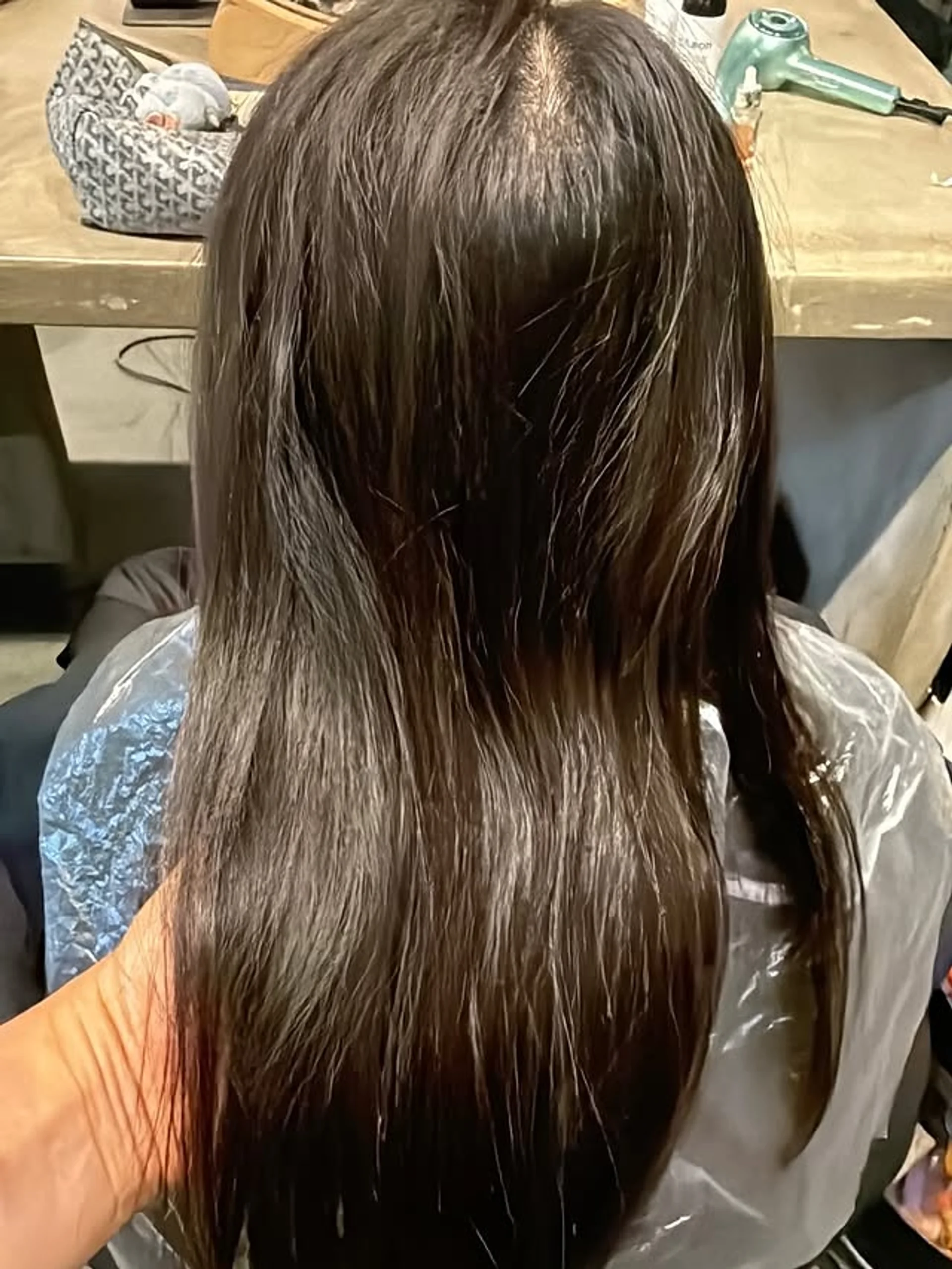 A woman with incredibly sleek, glossy long straight dark hair, representing the Bio-Luxe Health trend in San Francisco for 2026. - Preview 3