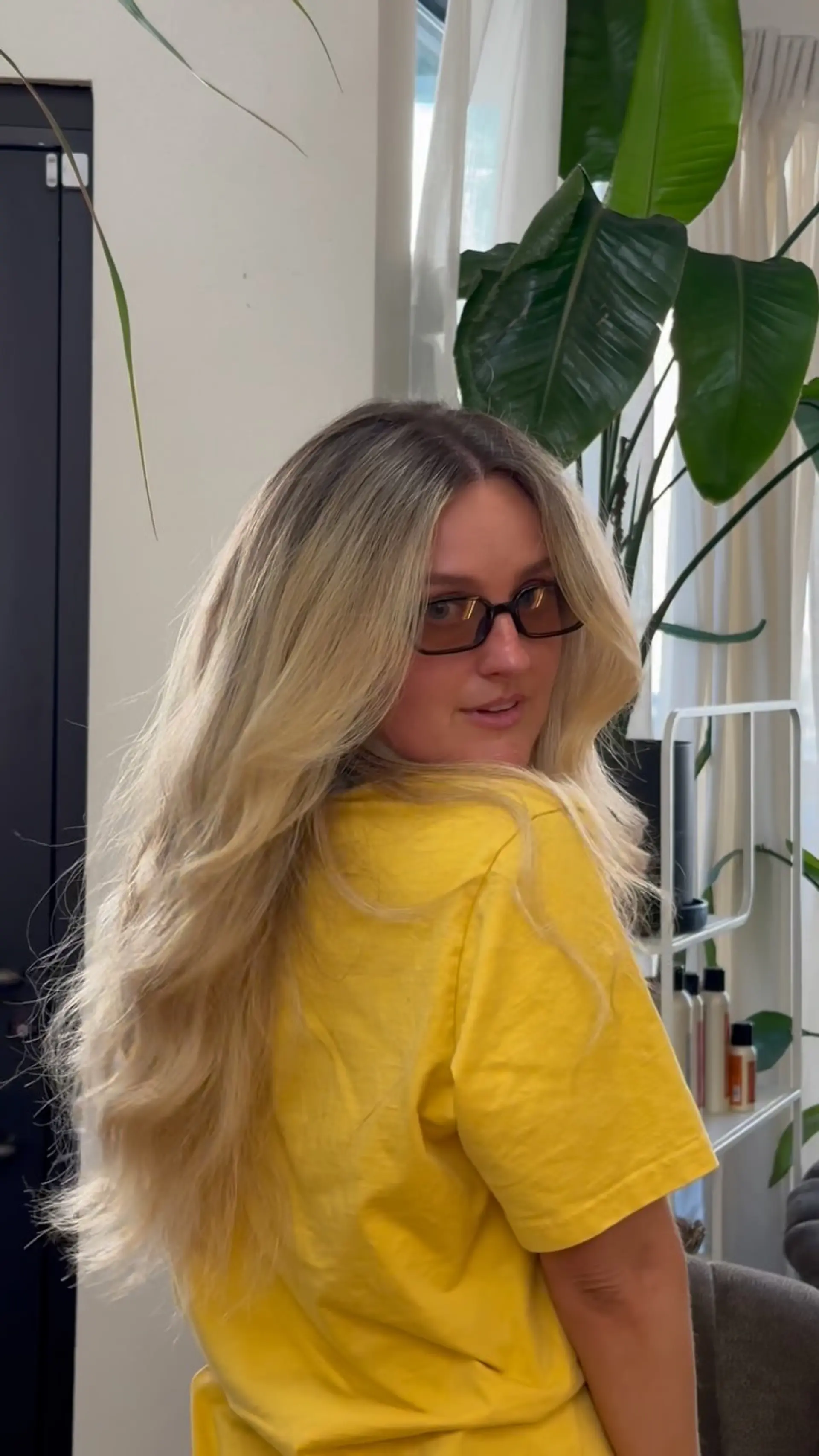 Long, luminous blonde hair styled into a big, bouncy blowout with soft face-framing curtain layers and textured movement throughout the ends. 1