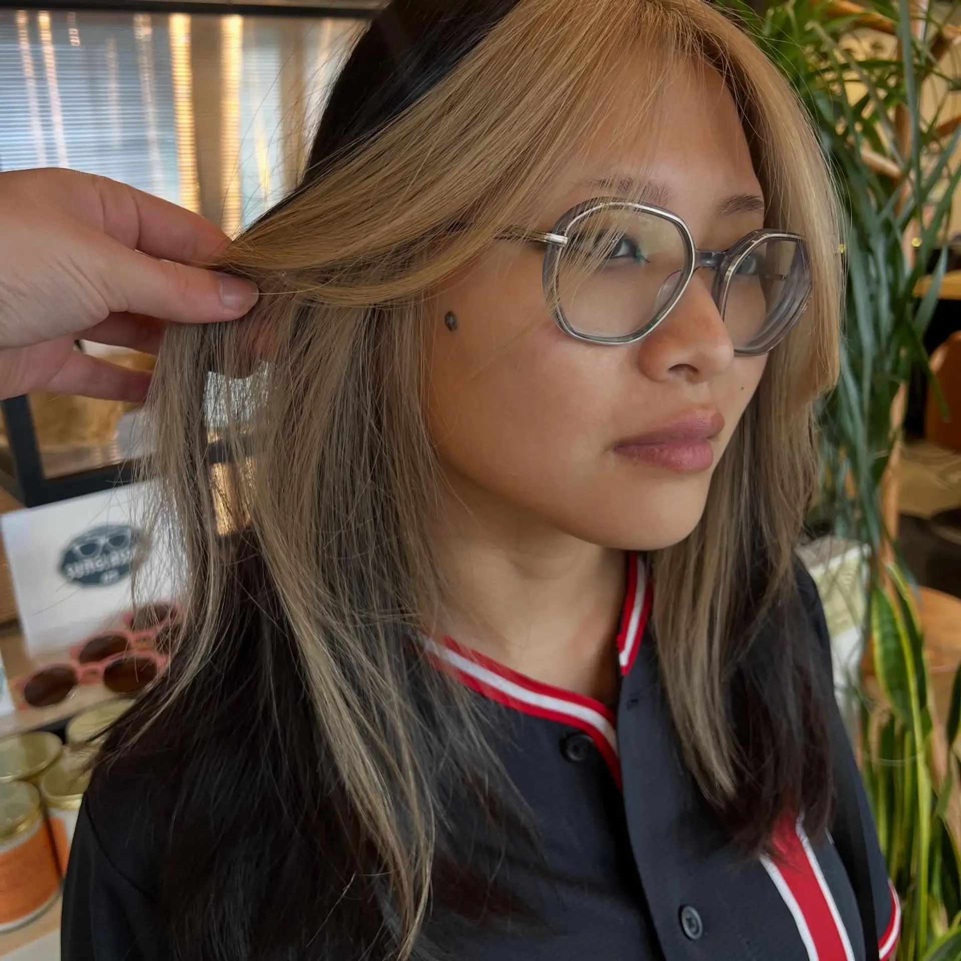 Medium-length layered style featuring high-contrast blonde color blocking around the face against a dark base. 1
