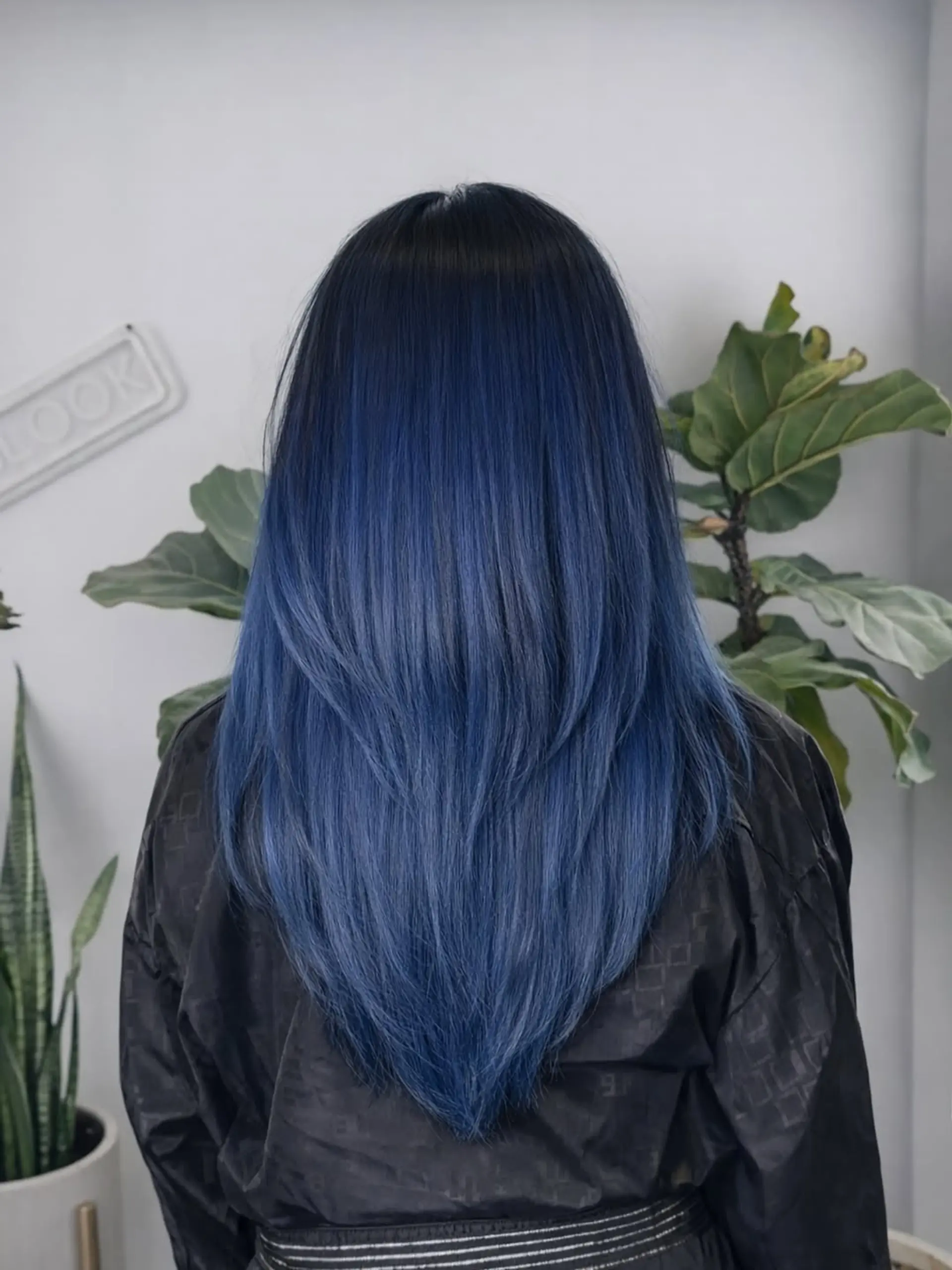 Long, straight hair with a deep V-shaped cut and layers, transitioned from dark roots to a bold midnight blue ombré. 1