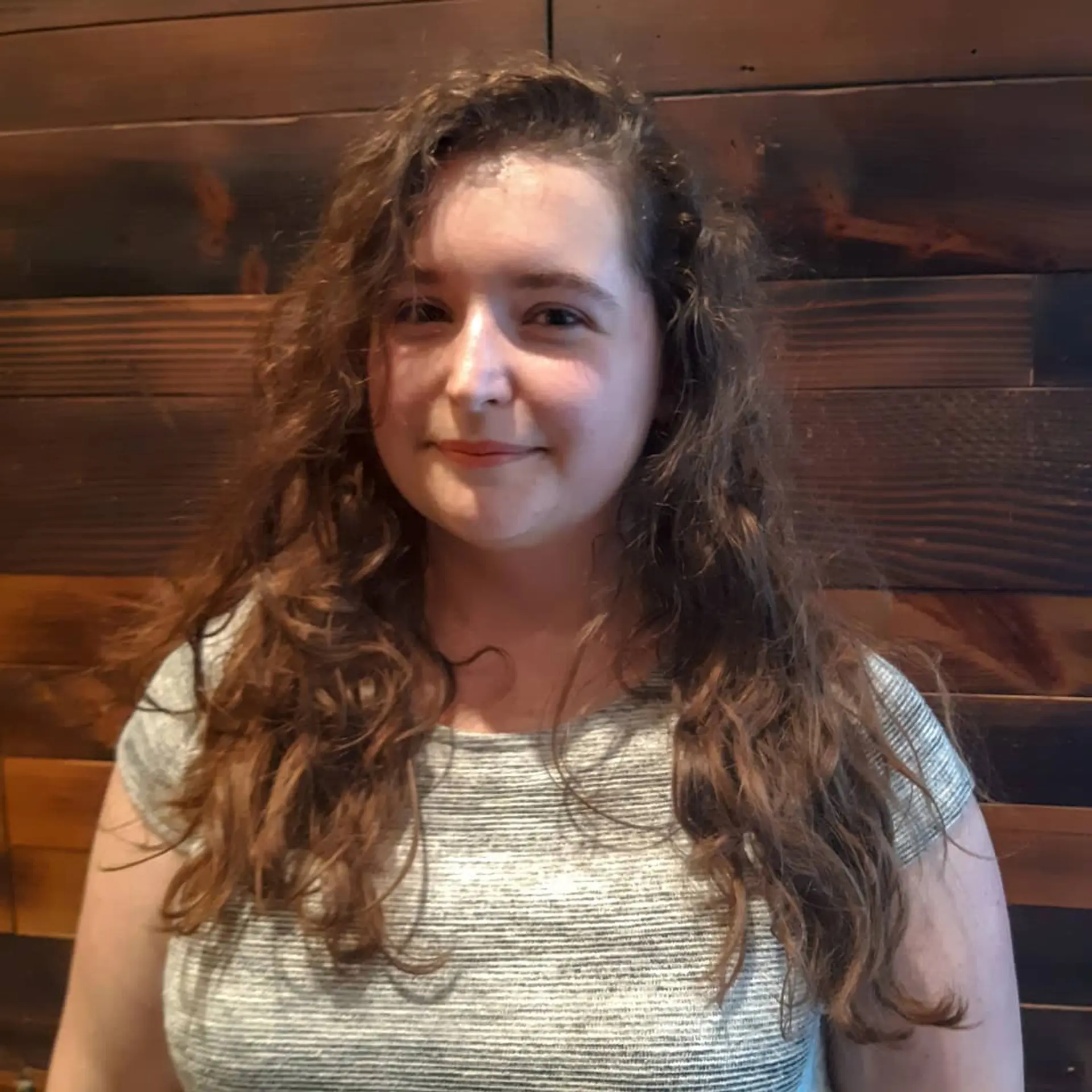 A short, textured pixie cut that enhances natural curls and provides an effortless, stylish look. 3