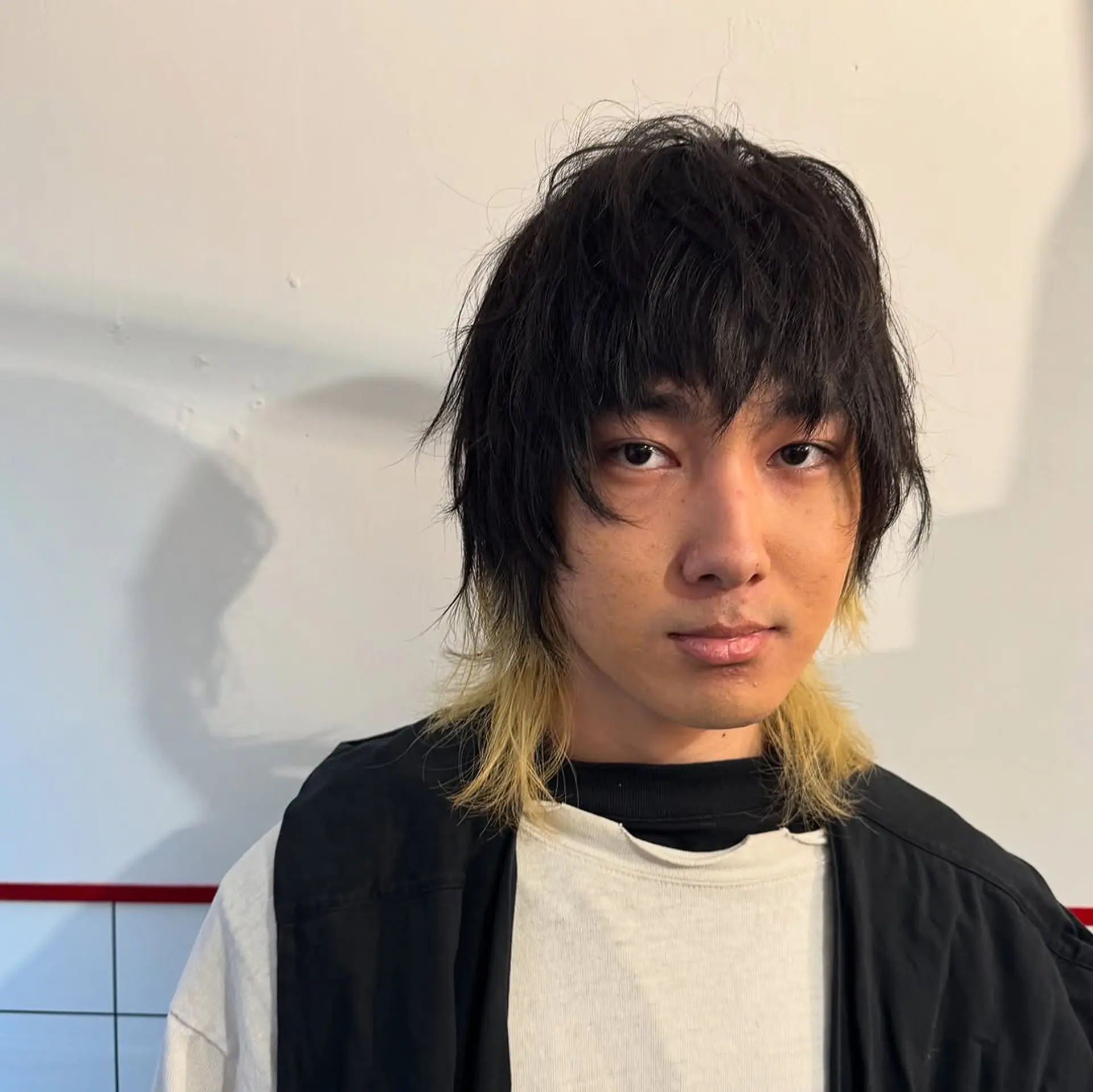 A textured shag cut featuring heavy, choppy layers and a modern mullet silhouette with contrasting blonde tips at the ends. 1