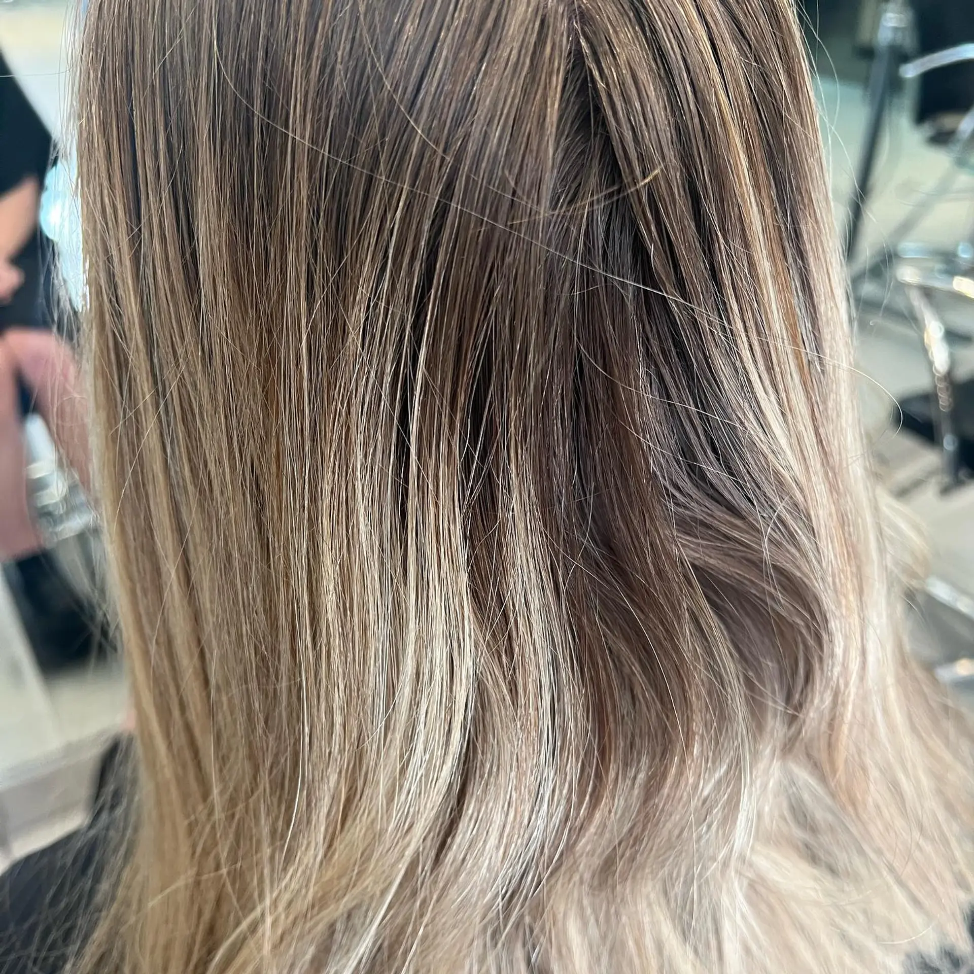 Finely woven cool-toned blonde highlights blended seamlessly into a soft light brown base. 1