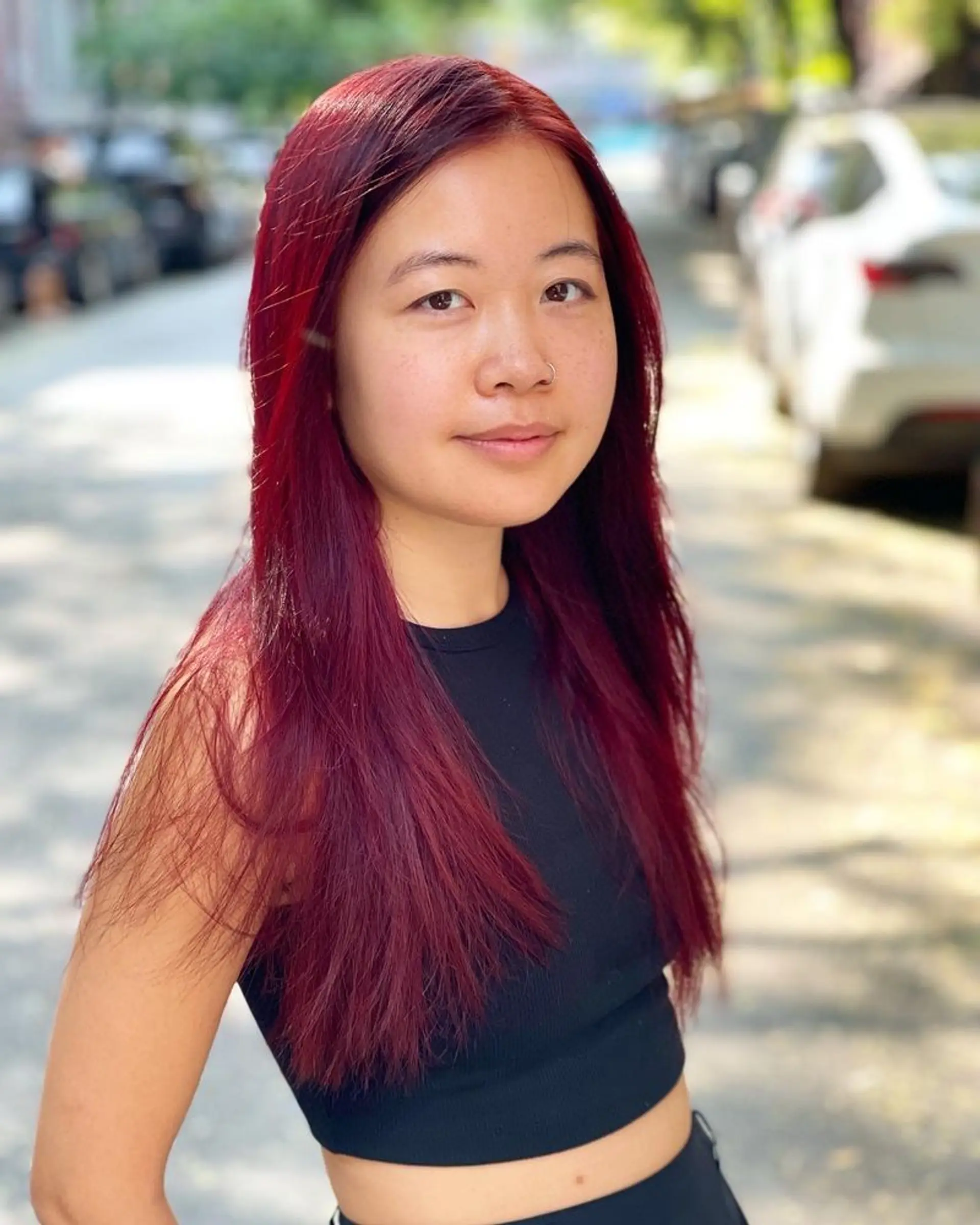 Long, straight hair with soft, face-framing layers in a vibrant burgundy. 1