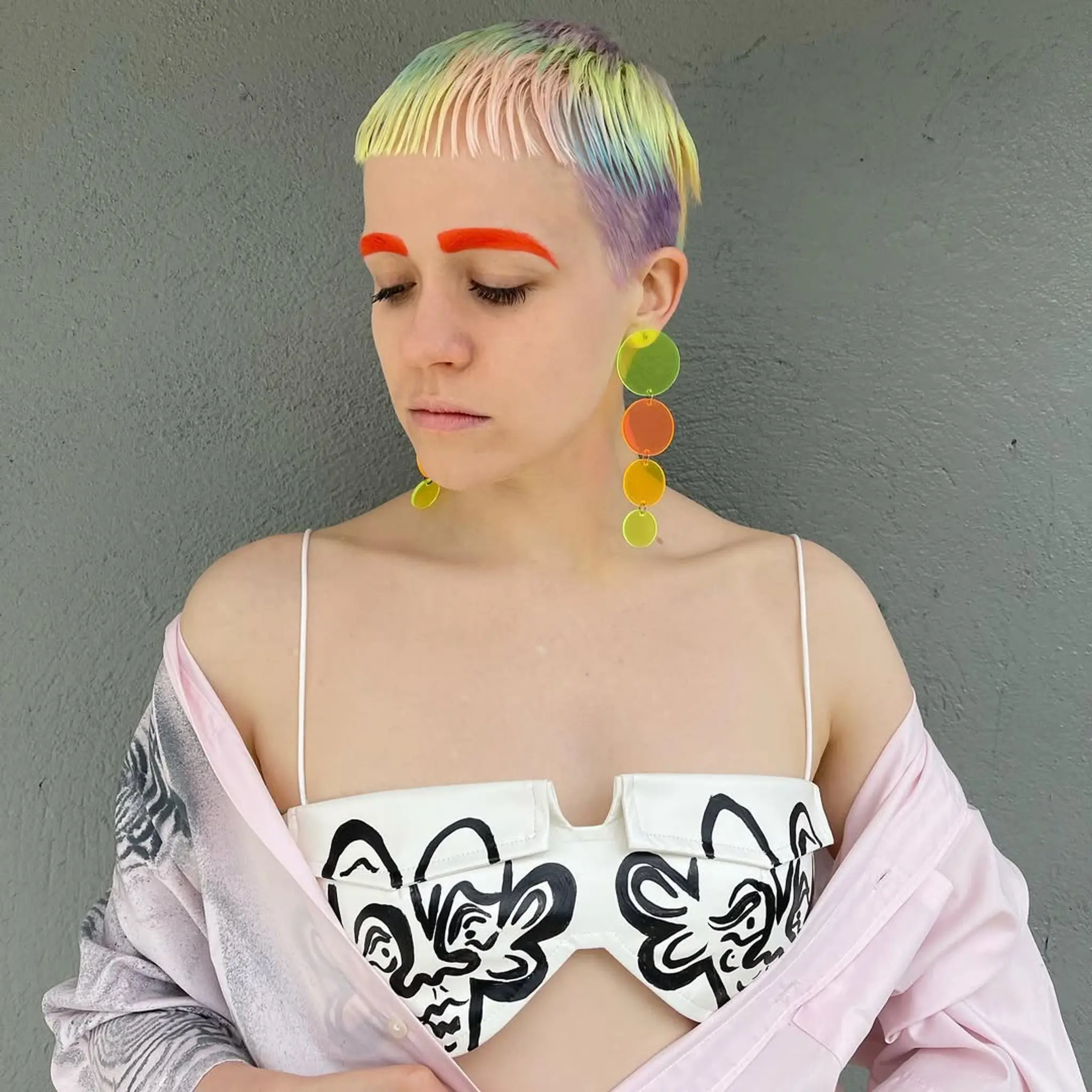 A vibrant, multi-colored pixie cut with straight, short hair. Features include a tapered nape and a bold fringe with pastel and neon colors. 2
