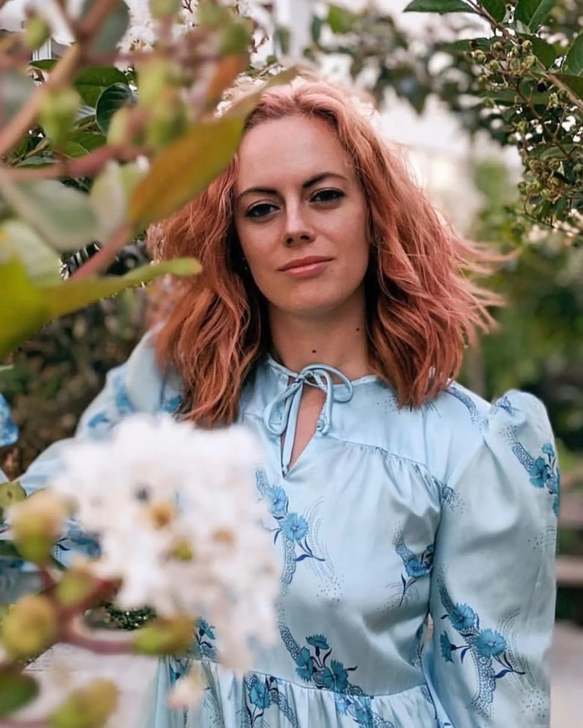 Medium-length, wavy hairstyle with a peach and strawberry blonde color blend. The waves are loose and natural, creating a bohemian chic look with a relaxed and casual vibe.

Spring 🌸HAIR🌸 is in full bloom 1