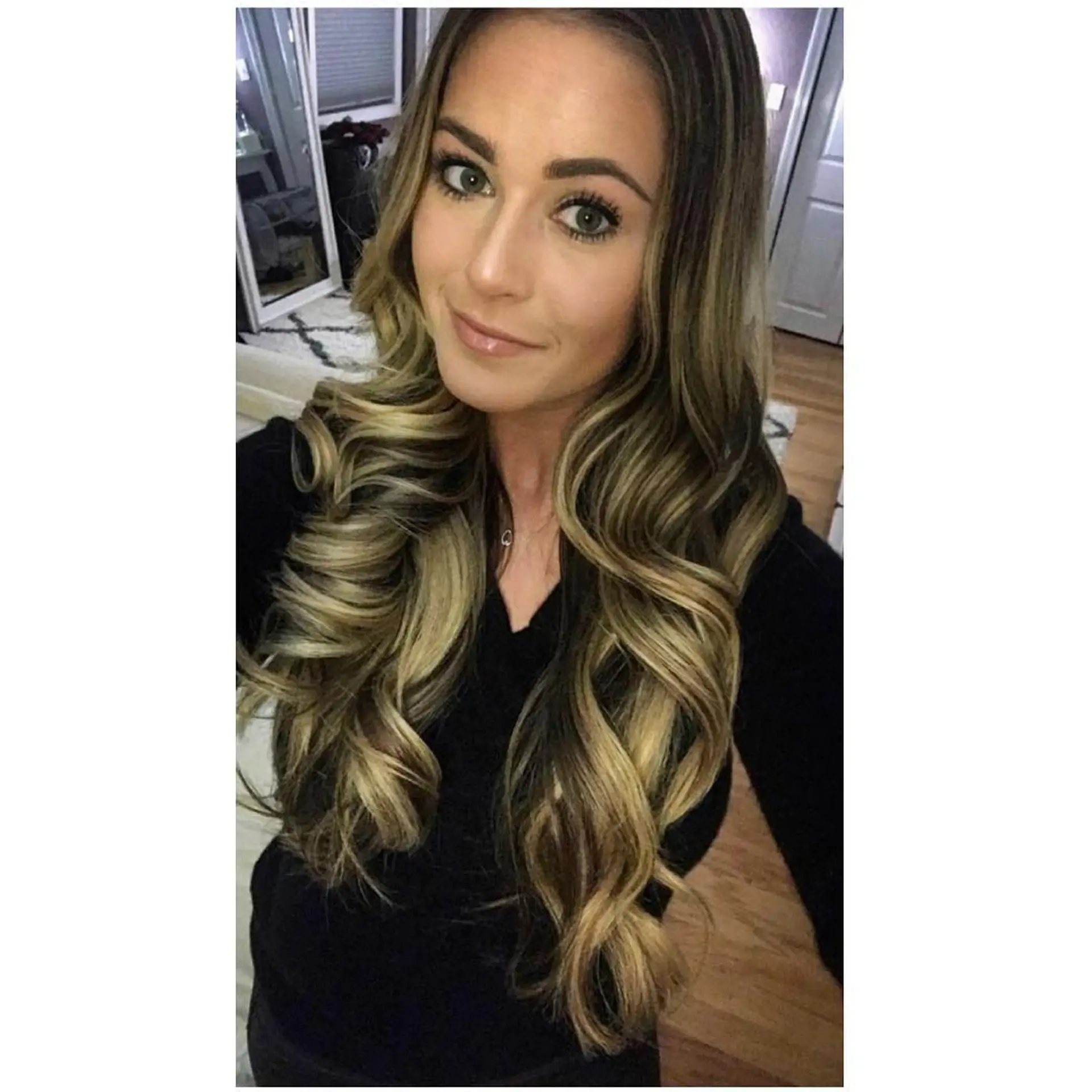 Dimensional bronde balayage on long hair styled in loose, bouncy curls. 1