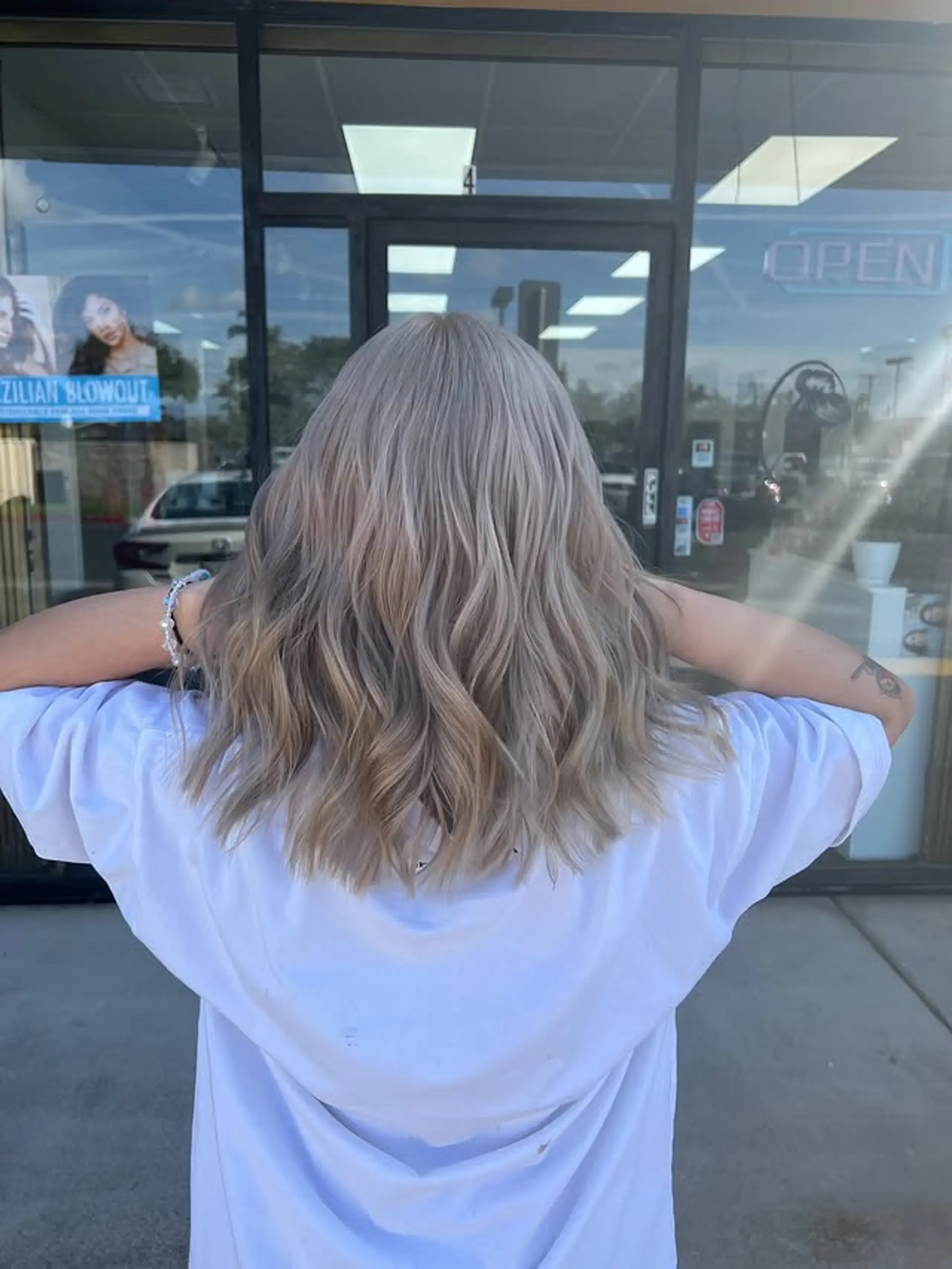 A wavy medium-length hairstyle with icy blonde tones. 1