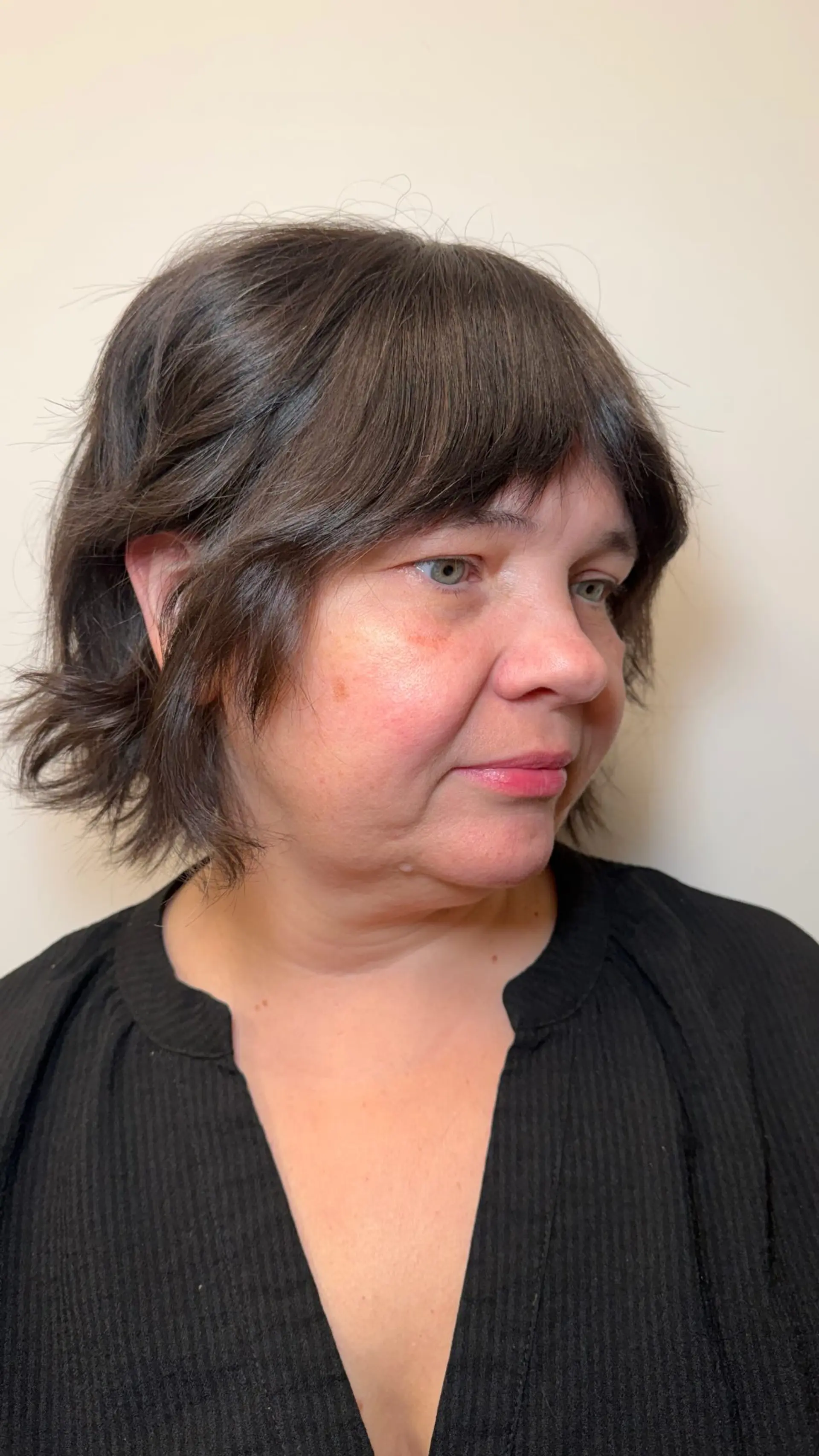 A textured chin-length short bob haircut with soft piecey fringe and flicked ends. 1