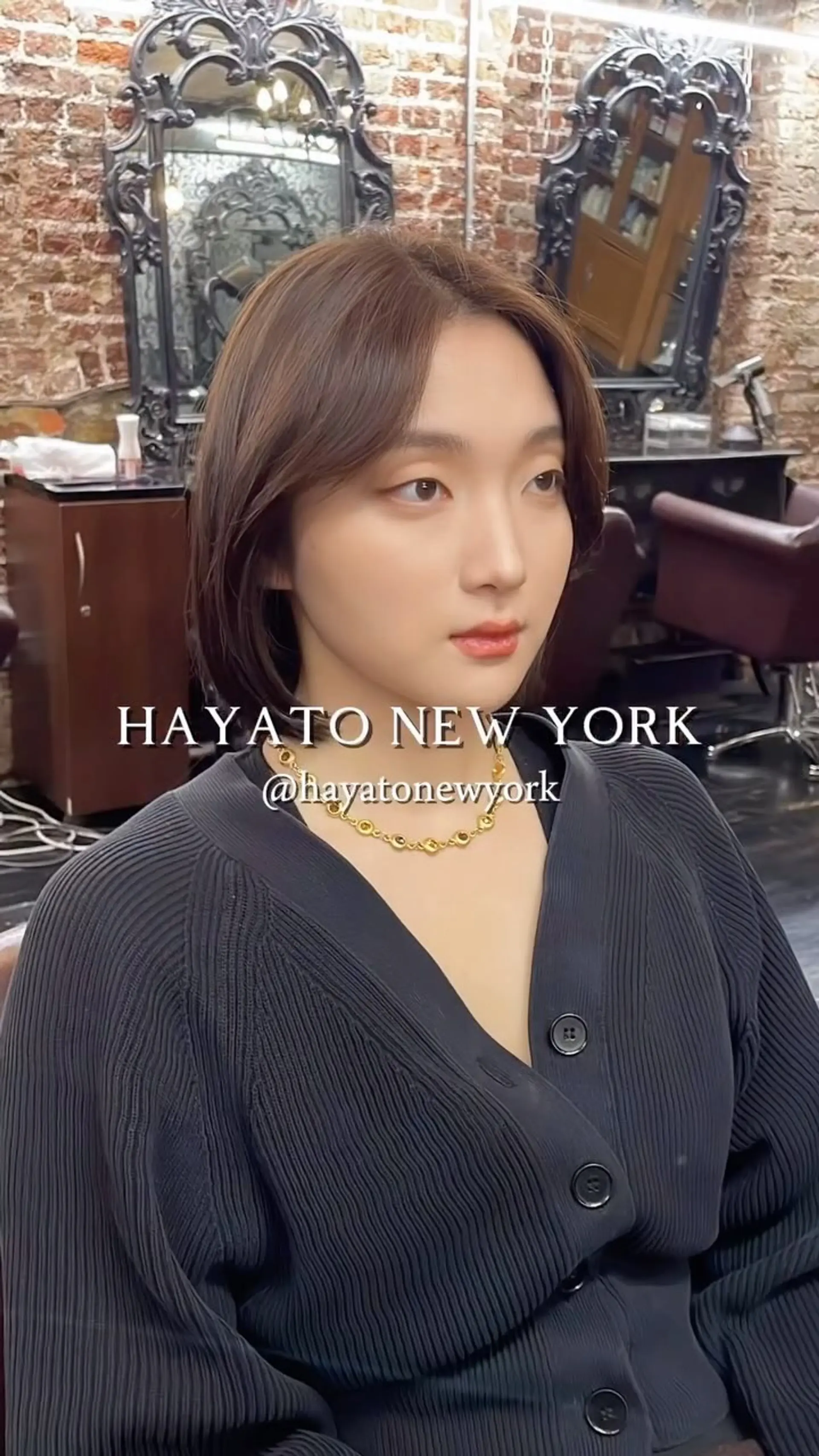 A sleek, chin-grazing layered bob with soft curtain bangs styled to frame the face with gently tucked ends. 1