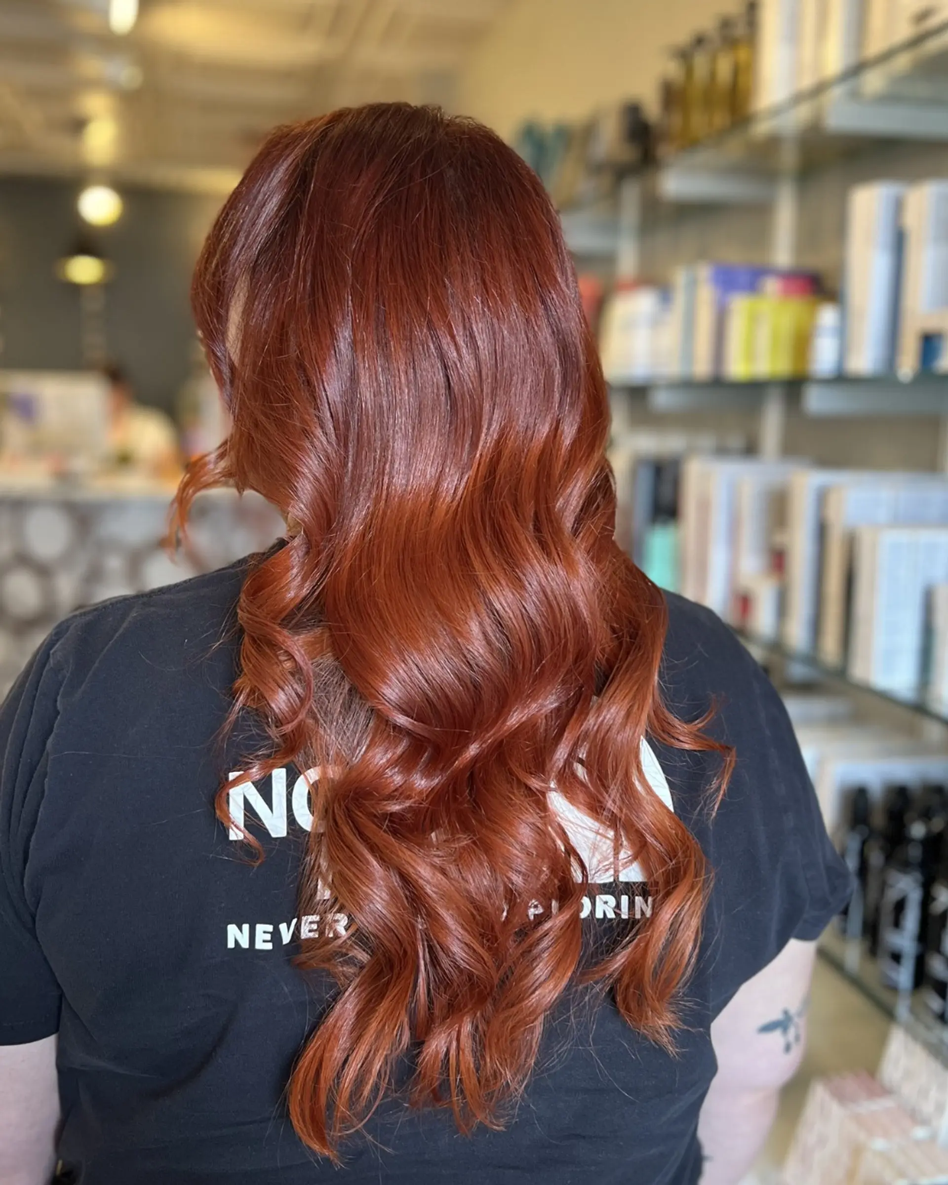 Long auburn and copper hair styled into loose, glossy cascading waves. 1