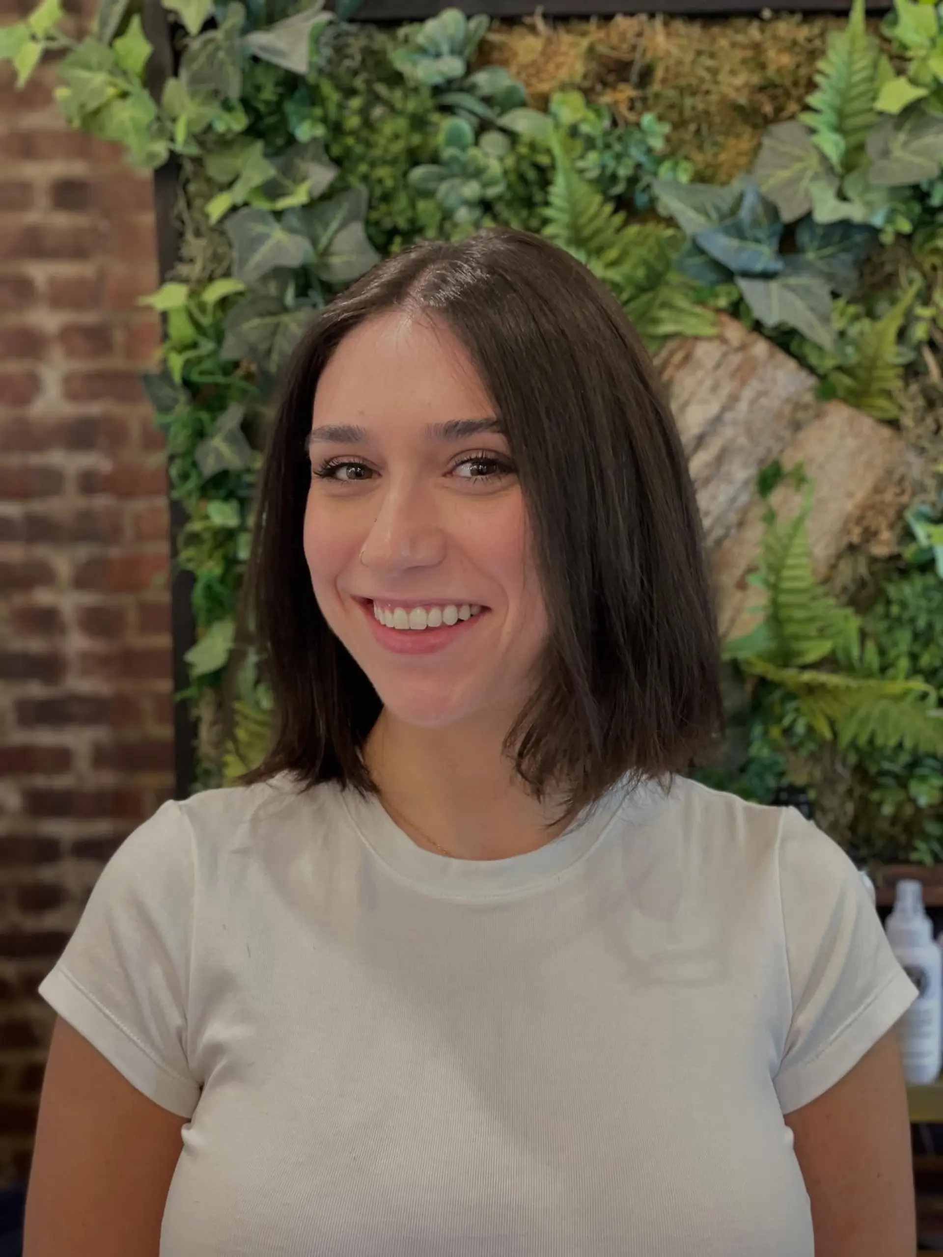 A sleek, shoulder-grazing dark brown bob haircut styled straight with a clean center part. 1