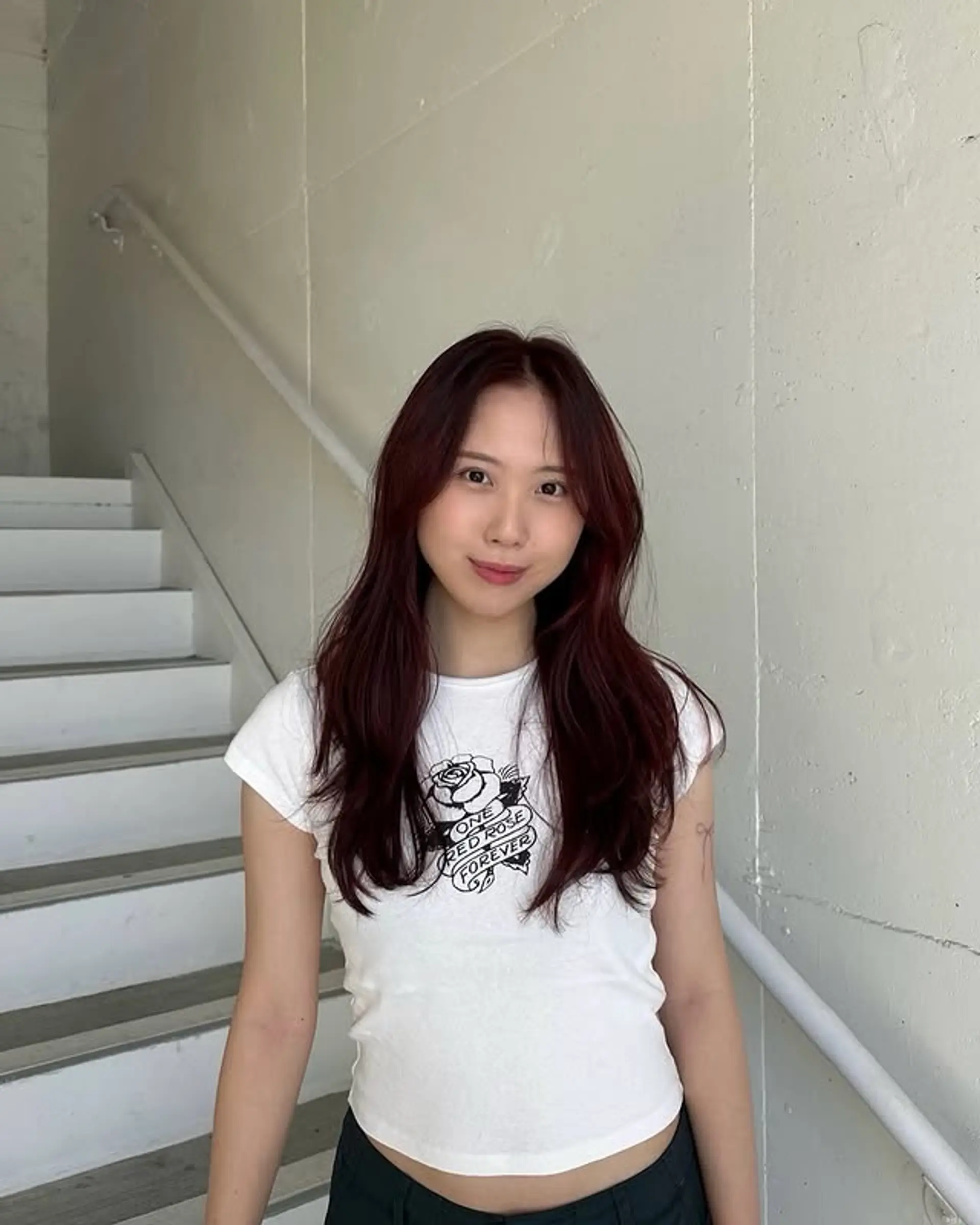 A medium length, layered wavy hairstyle with face-framing layers and a center part. 1