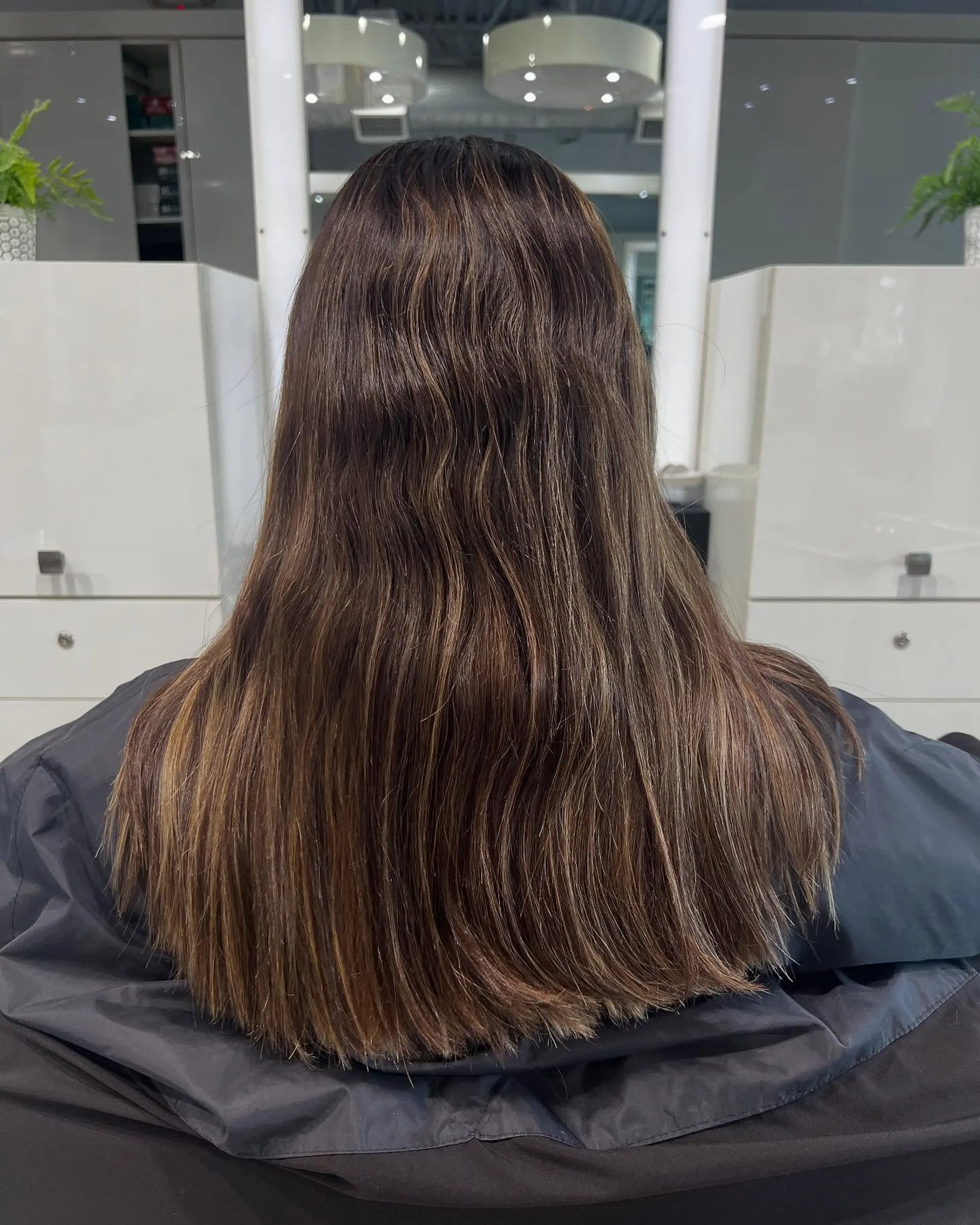 Long layered haircut with face-framing layers and a balayage color melt. 2