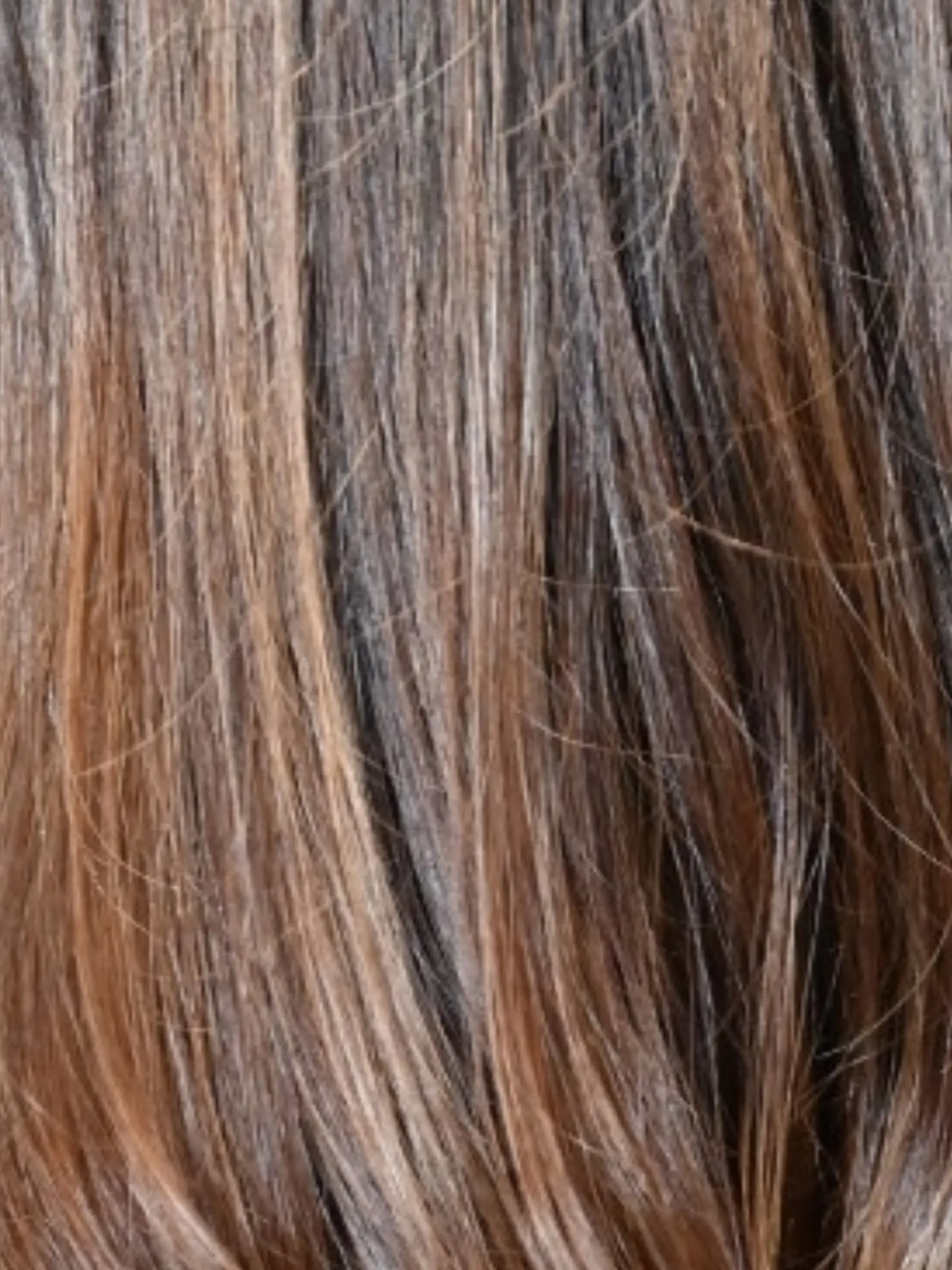 A close-up view of dark brown hair enhanced with fine caramel and golden highlights. 1