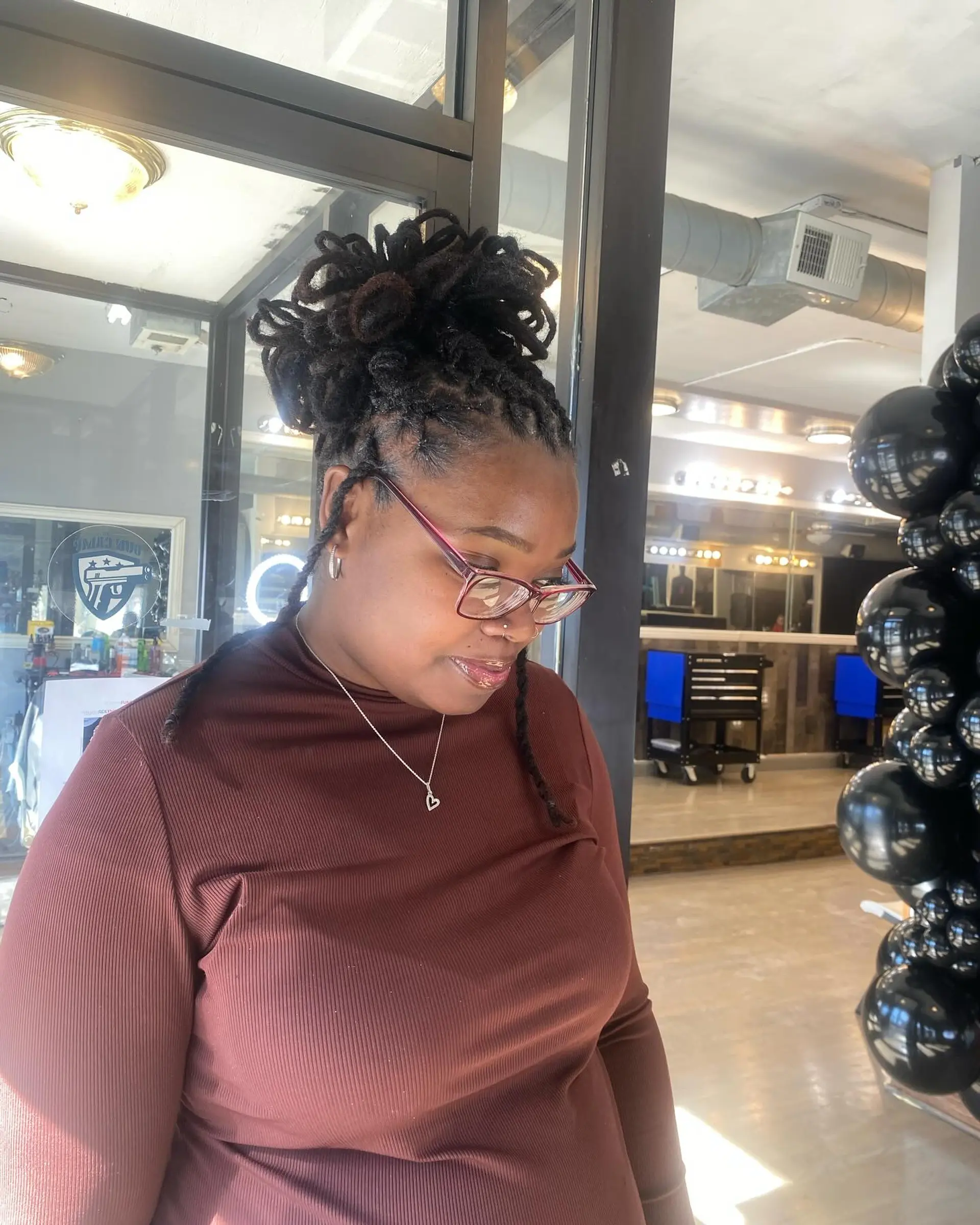 A stylish loc bun updo, perfect for a chic and effortless look. 2