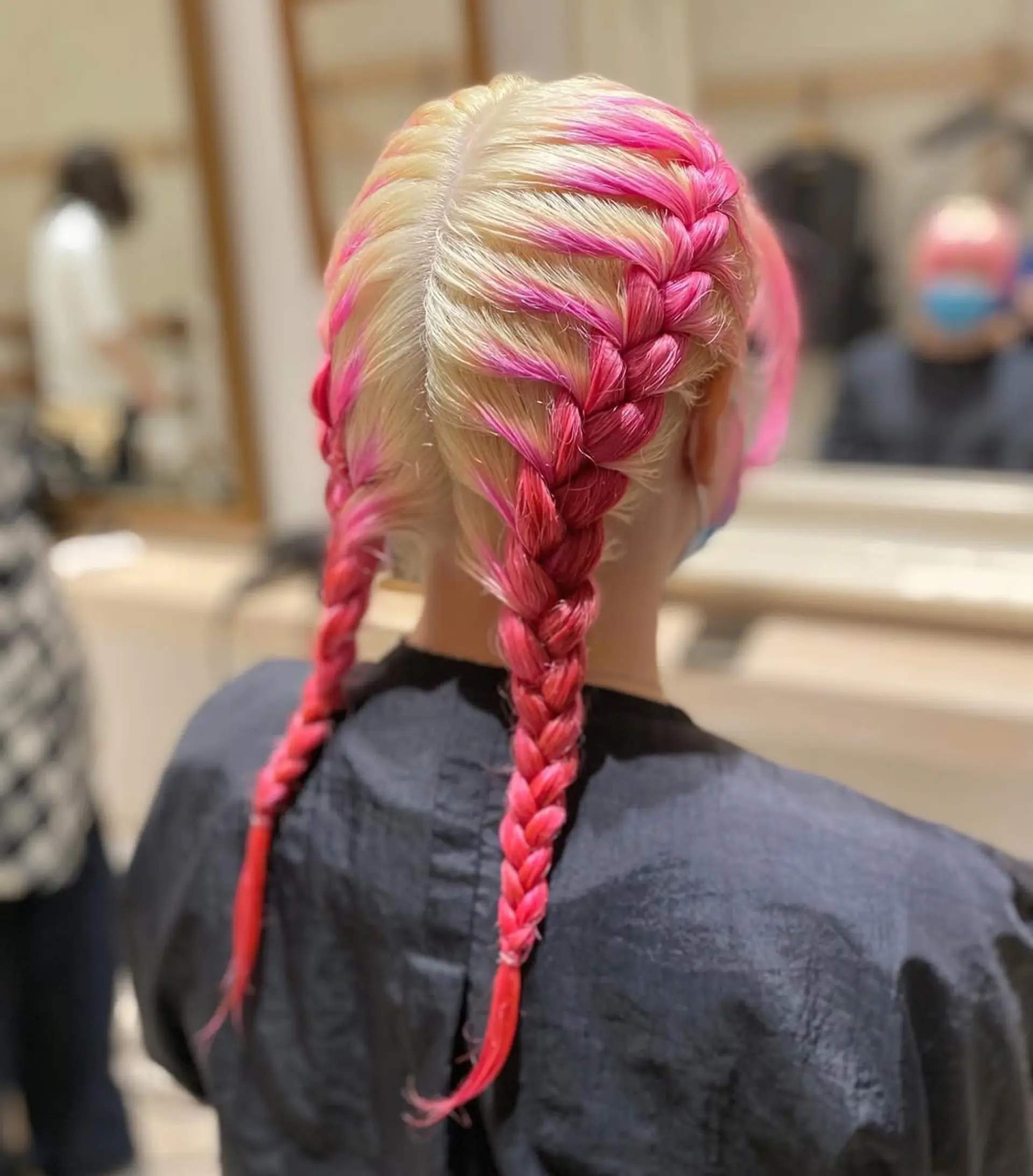 Two braided pigtails with vibrant pink streaks. 1
