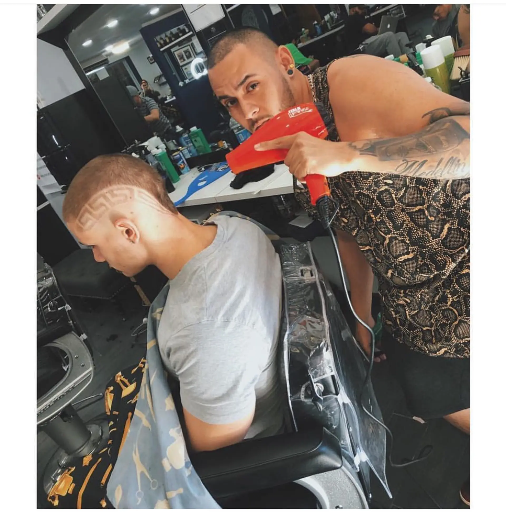 A close buzz cut featuring an intricate geometric Greek key pattern shaved into the side and temple. 1