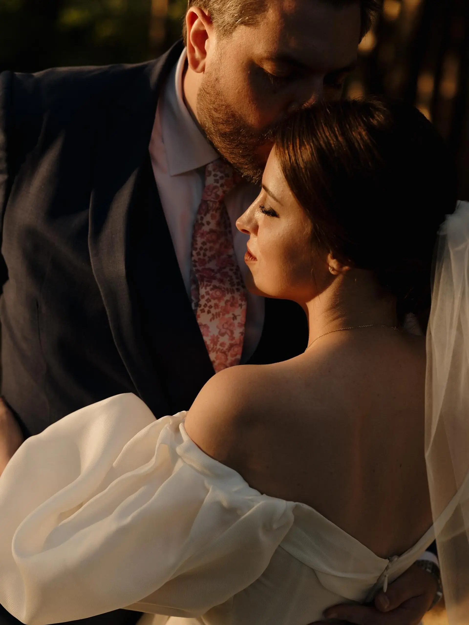 An elegant, polished bridal updo smoothly gathered back and paired with a veil. 1