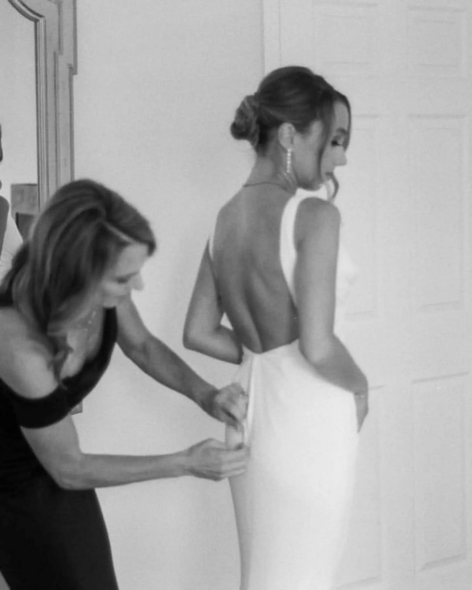 An elegant low bridal bun updo paired with soft face-framing tendrils. 1