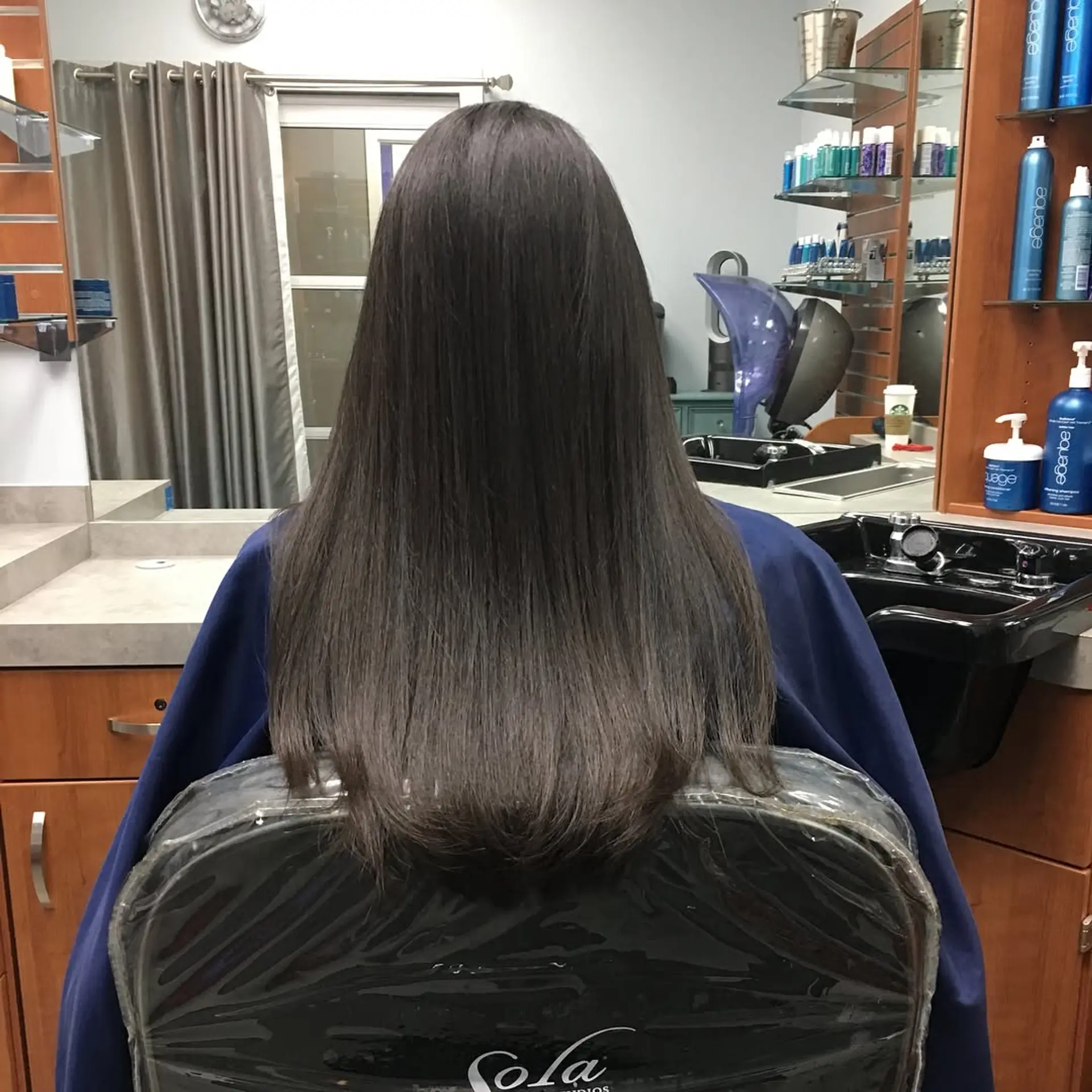Long, sleek straight dark hair styled smooth with softly rounded ends. 1
