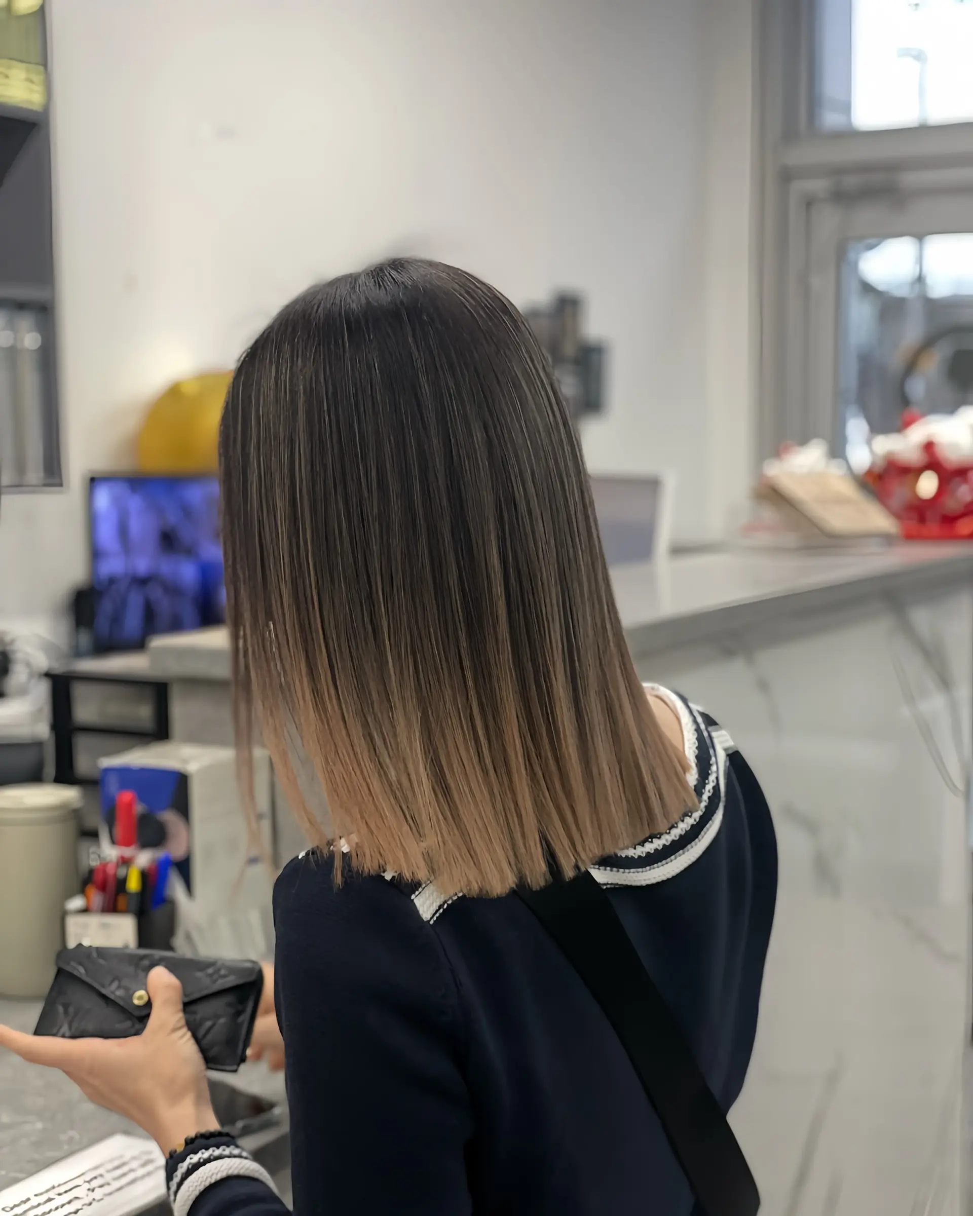 A sleek, straight, medium-length blunt bob with a subtle bronde ombre. 1