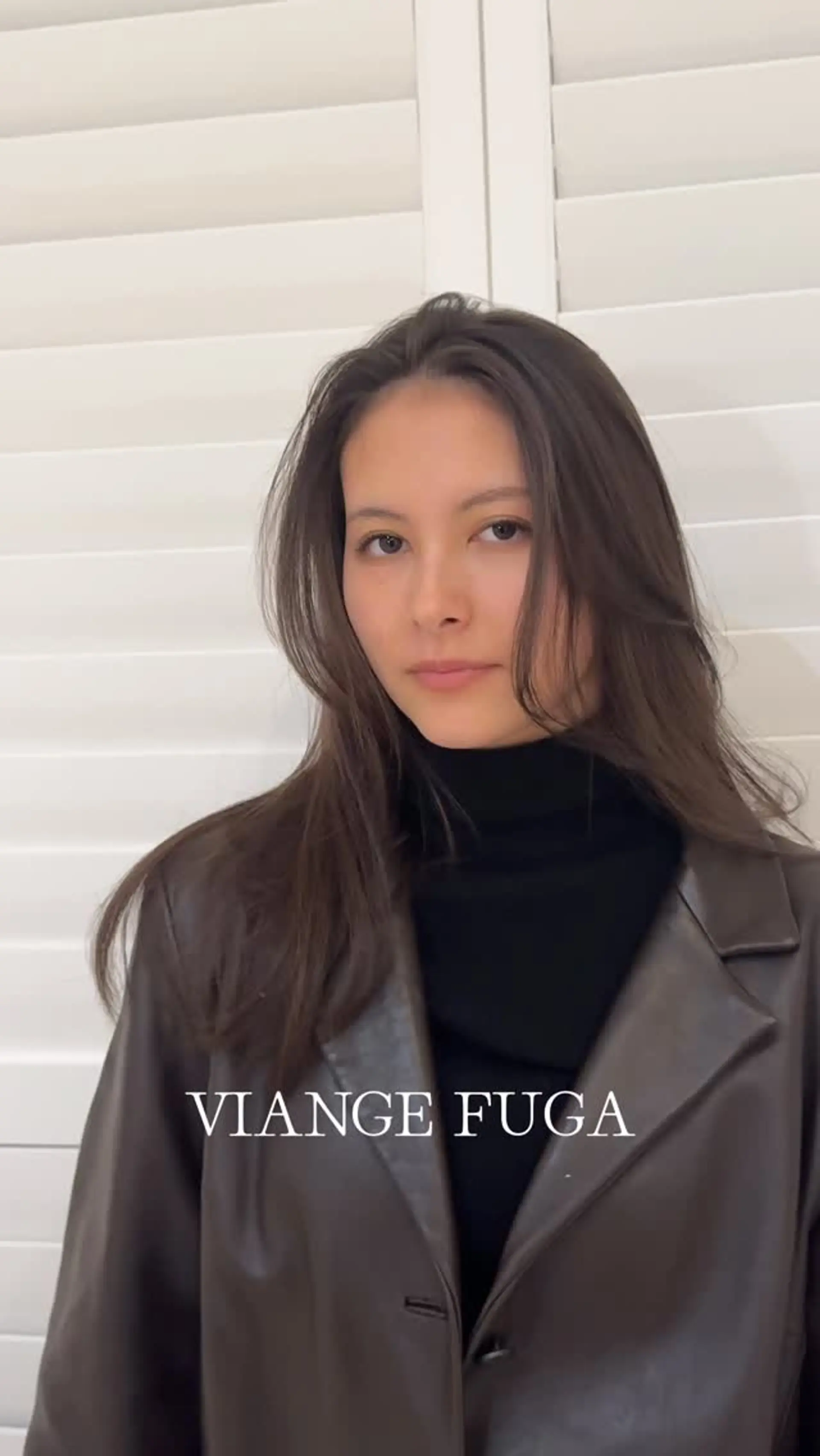 A sleek dark brown haircut featuring face-framing layers that curve softly around the cheeks and collarbone. 1