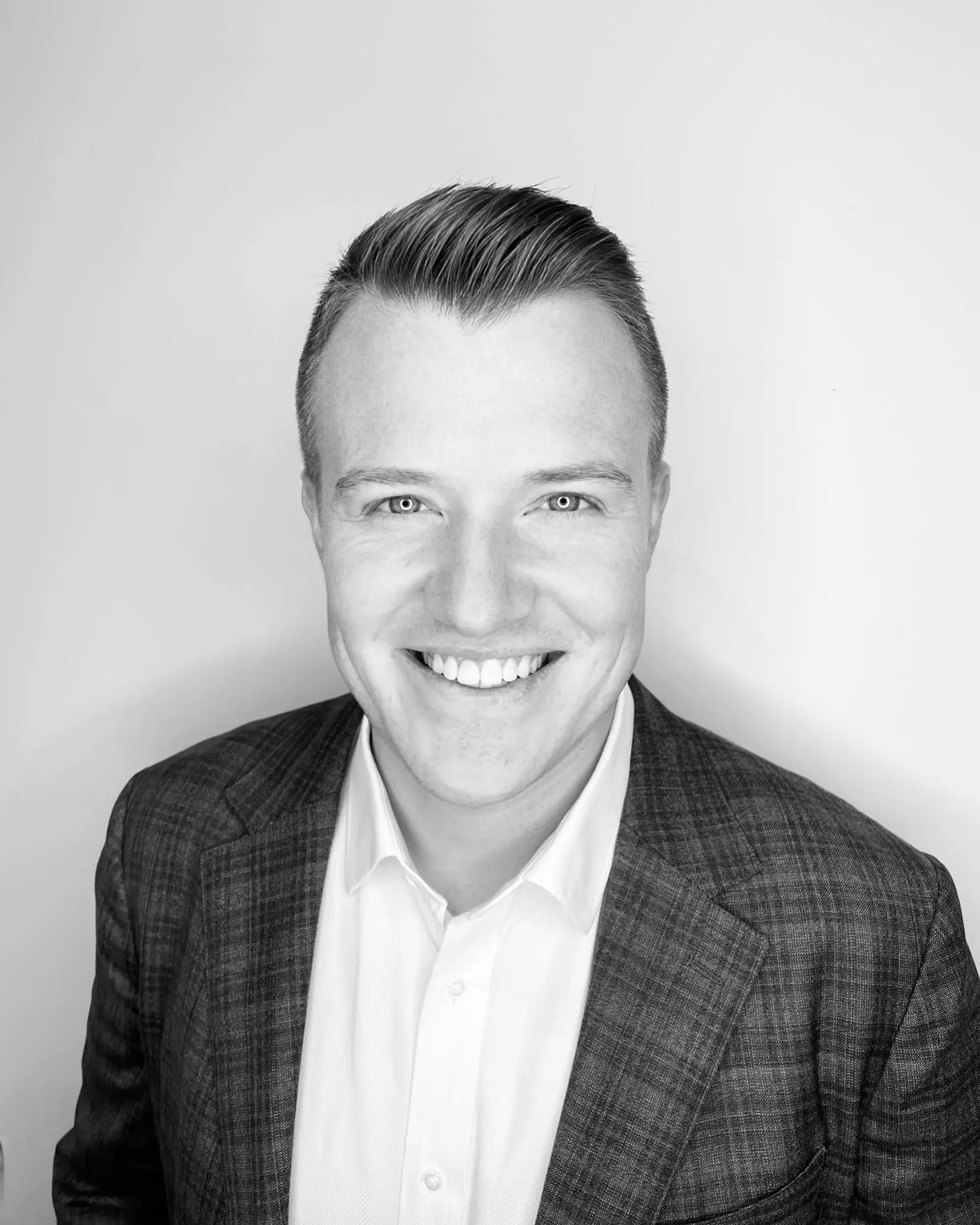 A classic men's short haircut styled with a clean taper on the sides and a textured, lifted top. 1