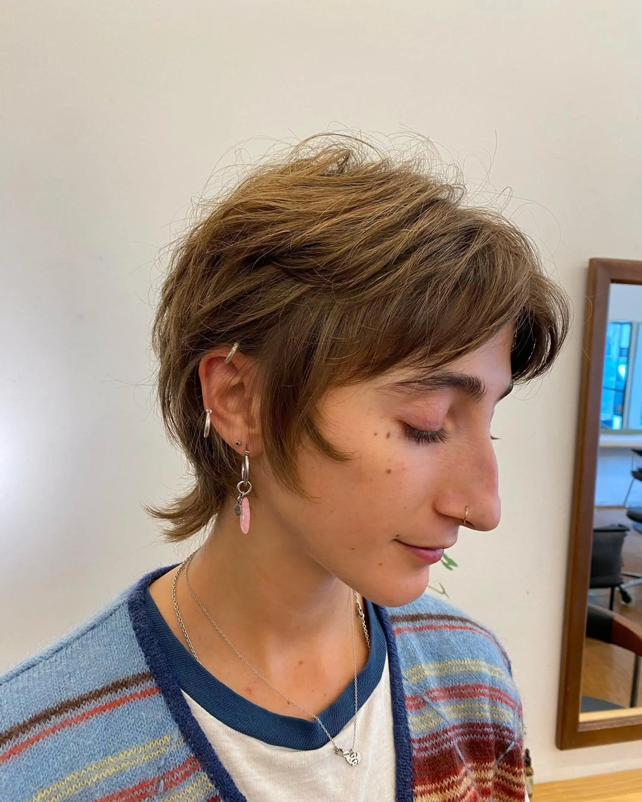 Soft, wavy, light brown hair cut short with feathered ends and textured layers.