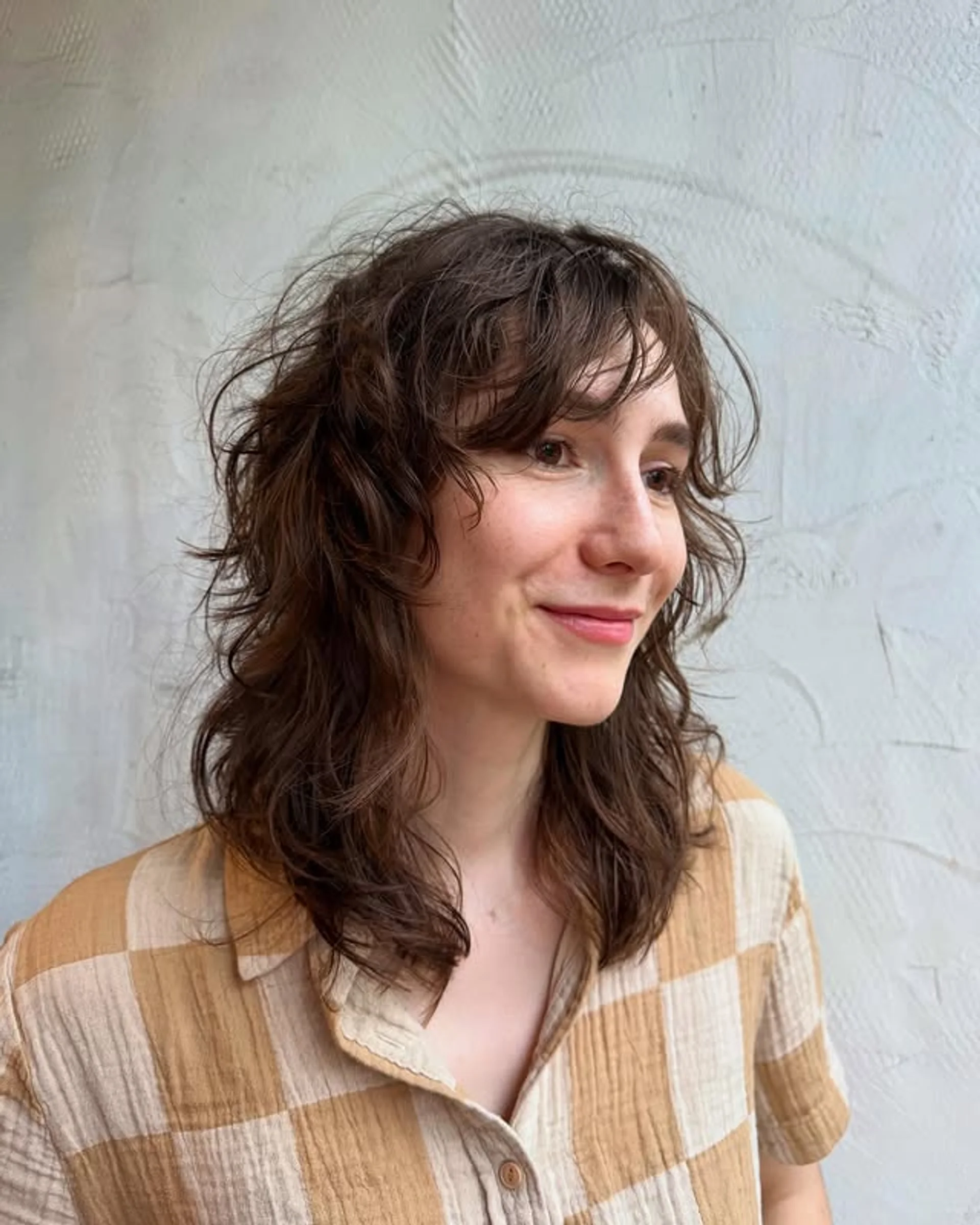 Long layered haircut with face-framing curtain bangs and soft highlights - Preview 2