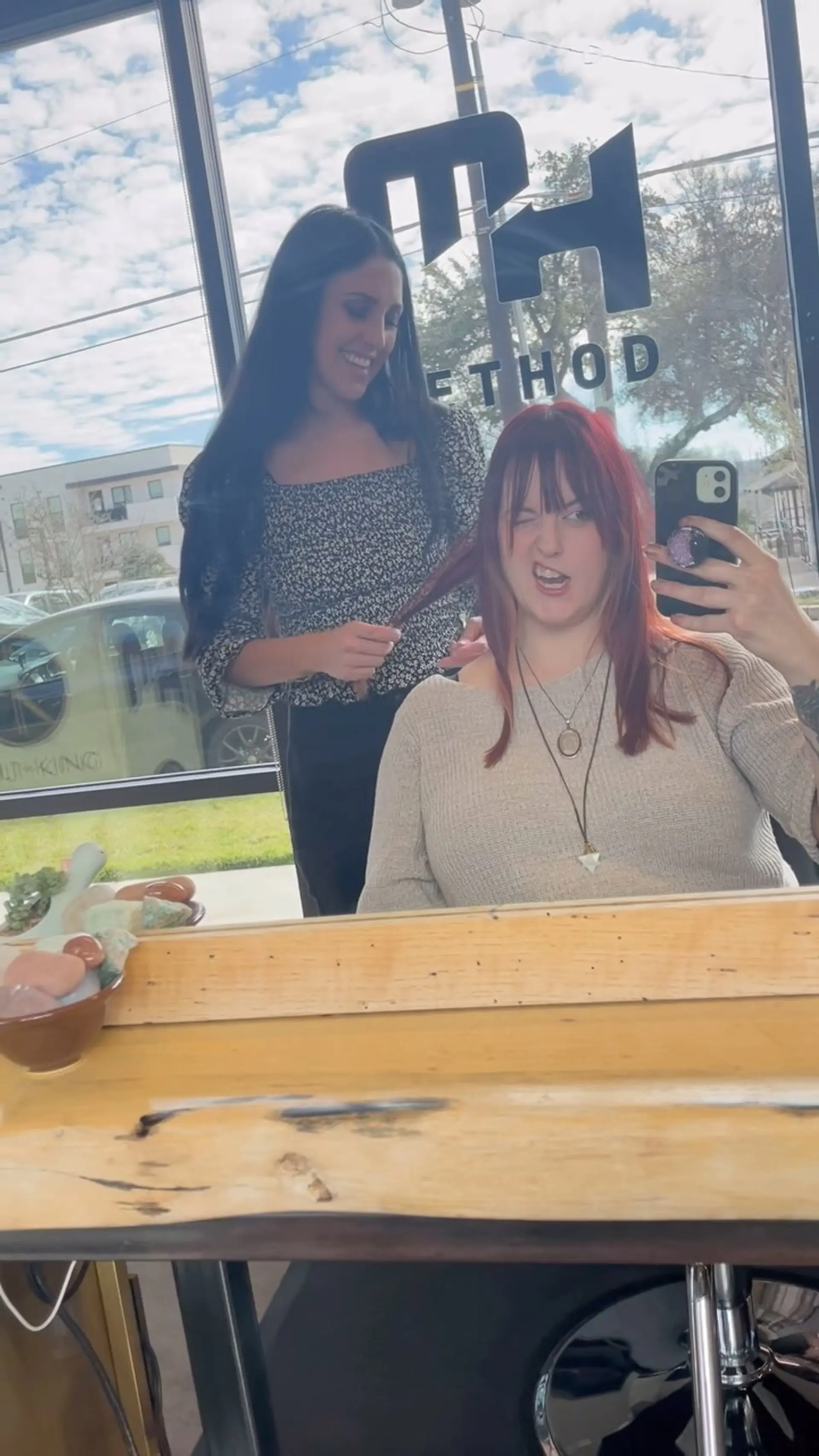A vibrant red medium-length haircut featuring full fringe bangs and soft face-framing layers. 1