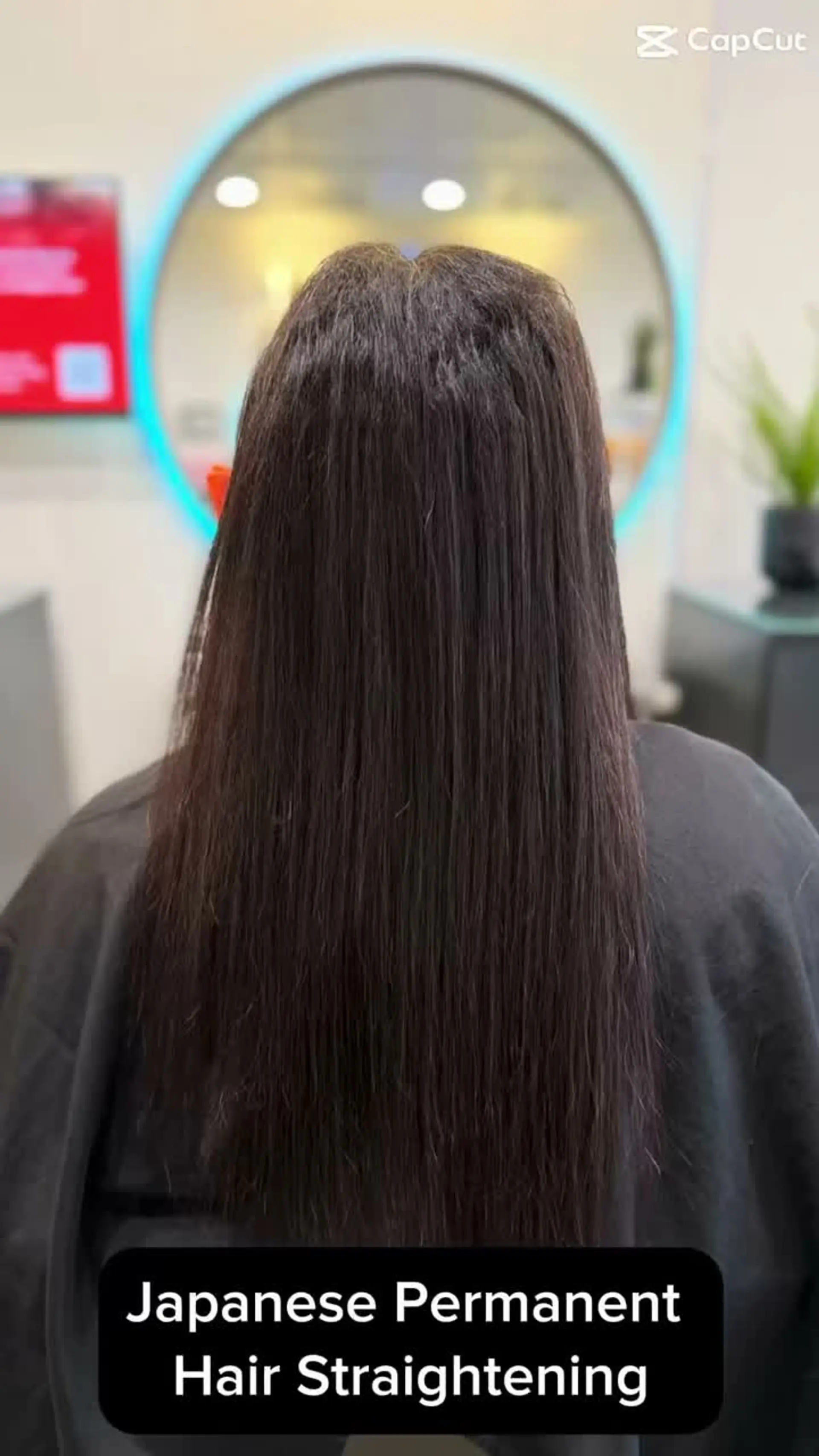 Long, sleek dark hair shown from behind following a Japanese permanent straightening touch-up. 1