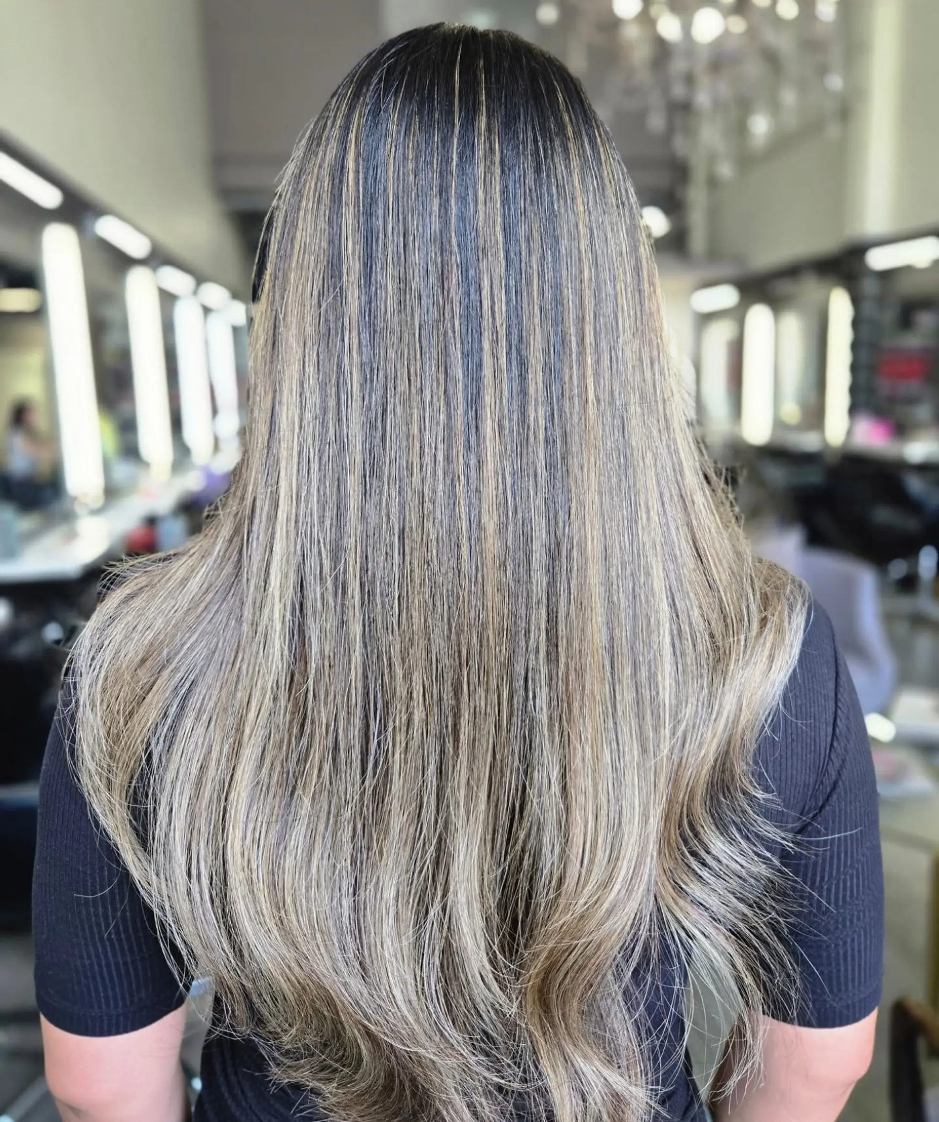 Long straight hair with fine blonde highlights throughout a dark base, ending in soft layered ends. 1