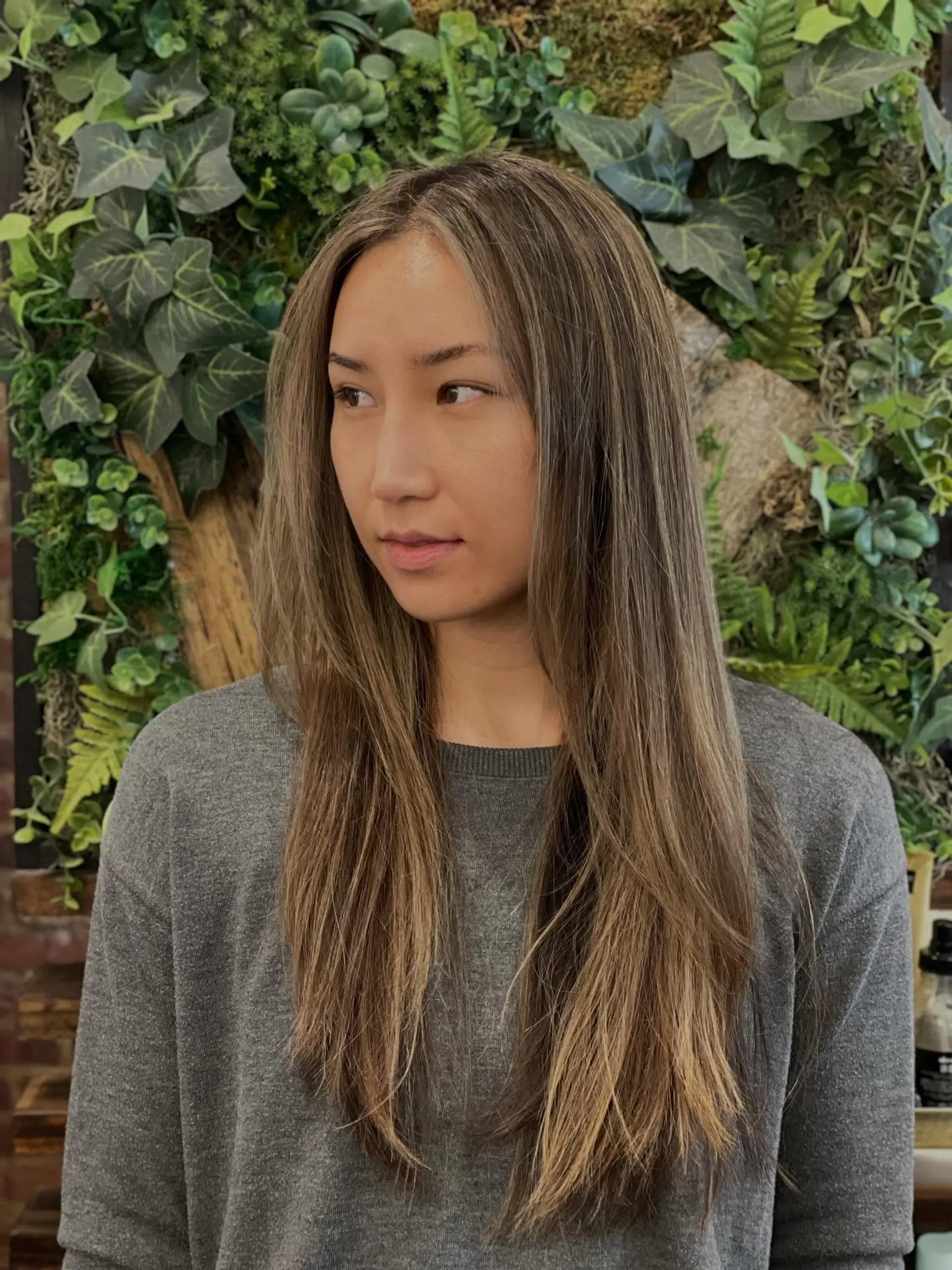 Long straight layered hair with soft, fine almond blonde highlights parted down the center. 1