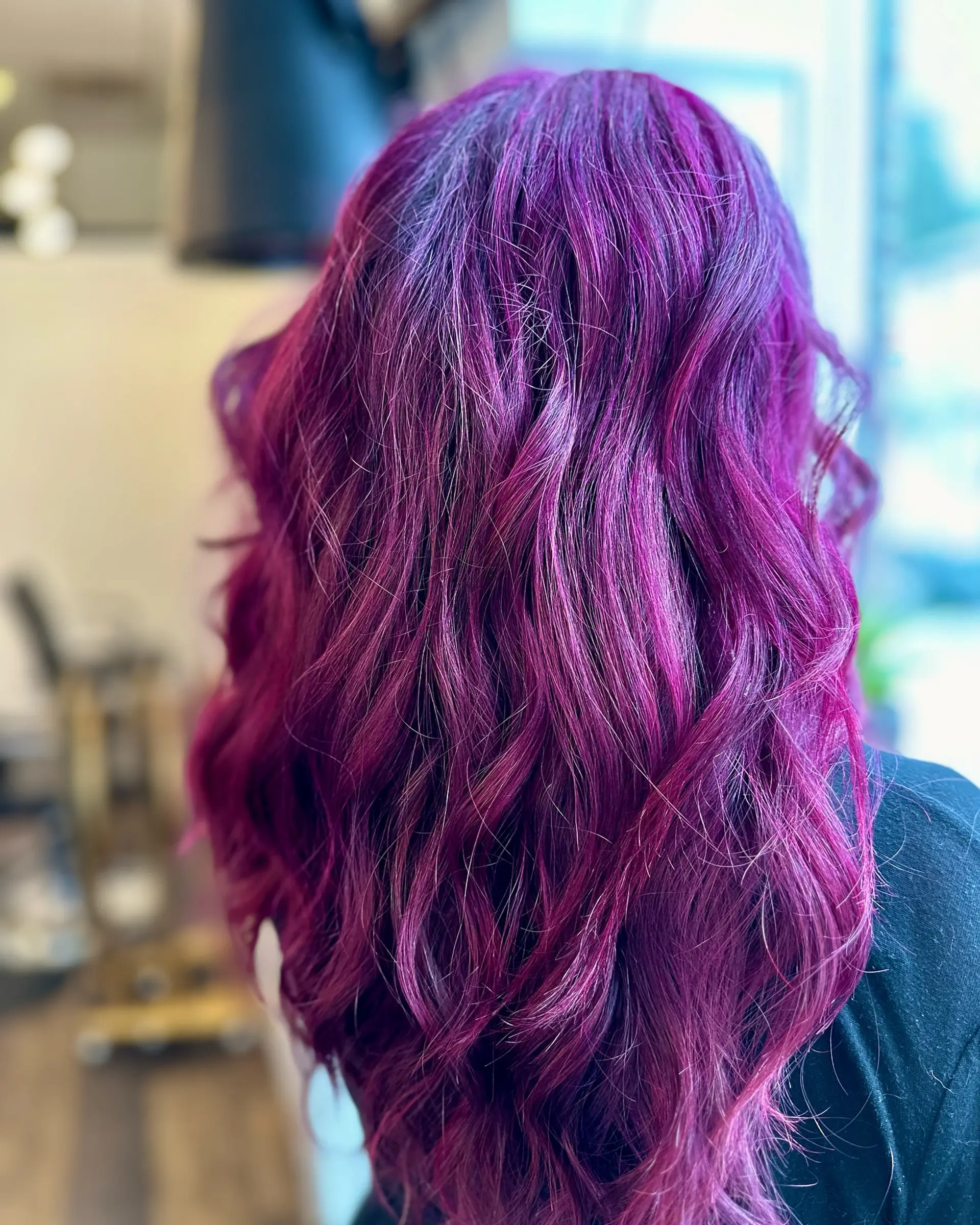 Vibrant magenta and violet-toned long hair styled with loose, dimensional waves. 1