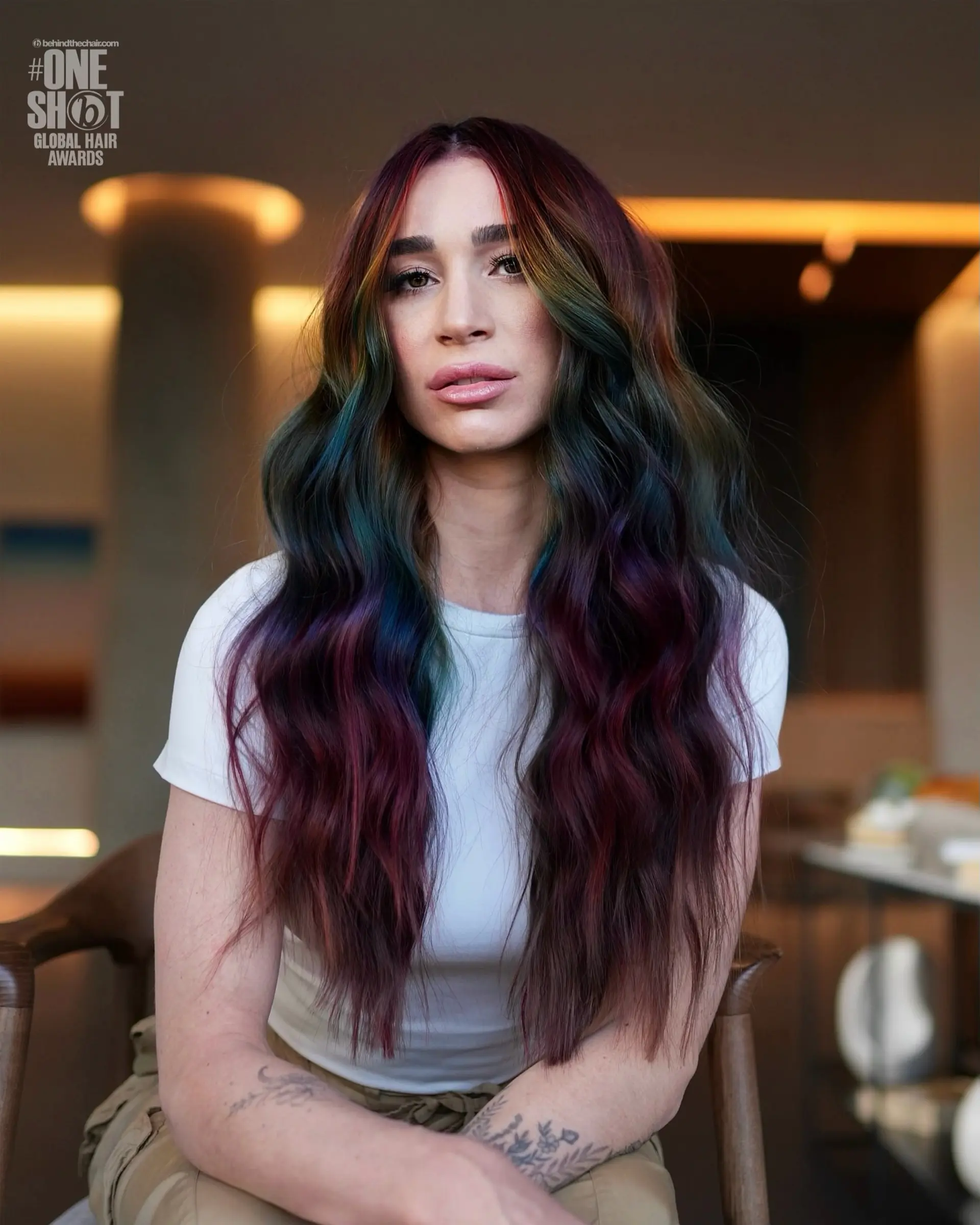 Long center-parted waves with dark roots and vibrant jewel-toned rainbow ribbons throughout. 1