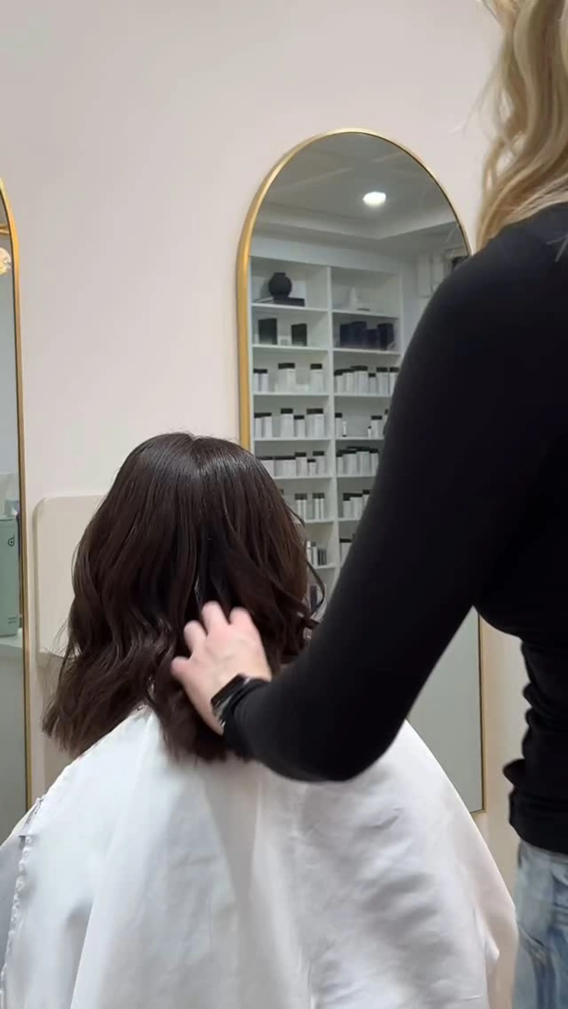 A shoulder-length textured long bob in a glossy chocolate brown tone styled with gentle waves. 1