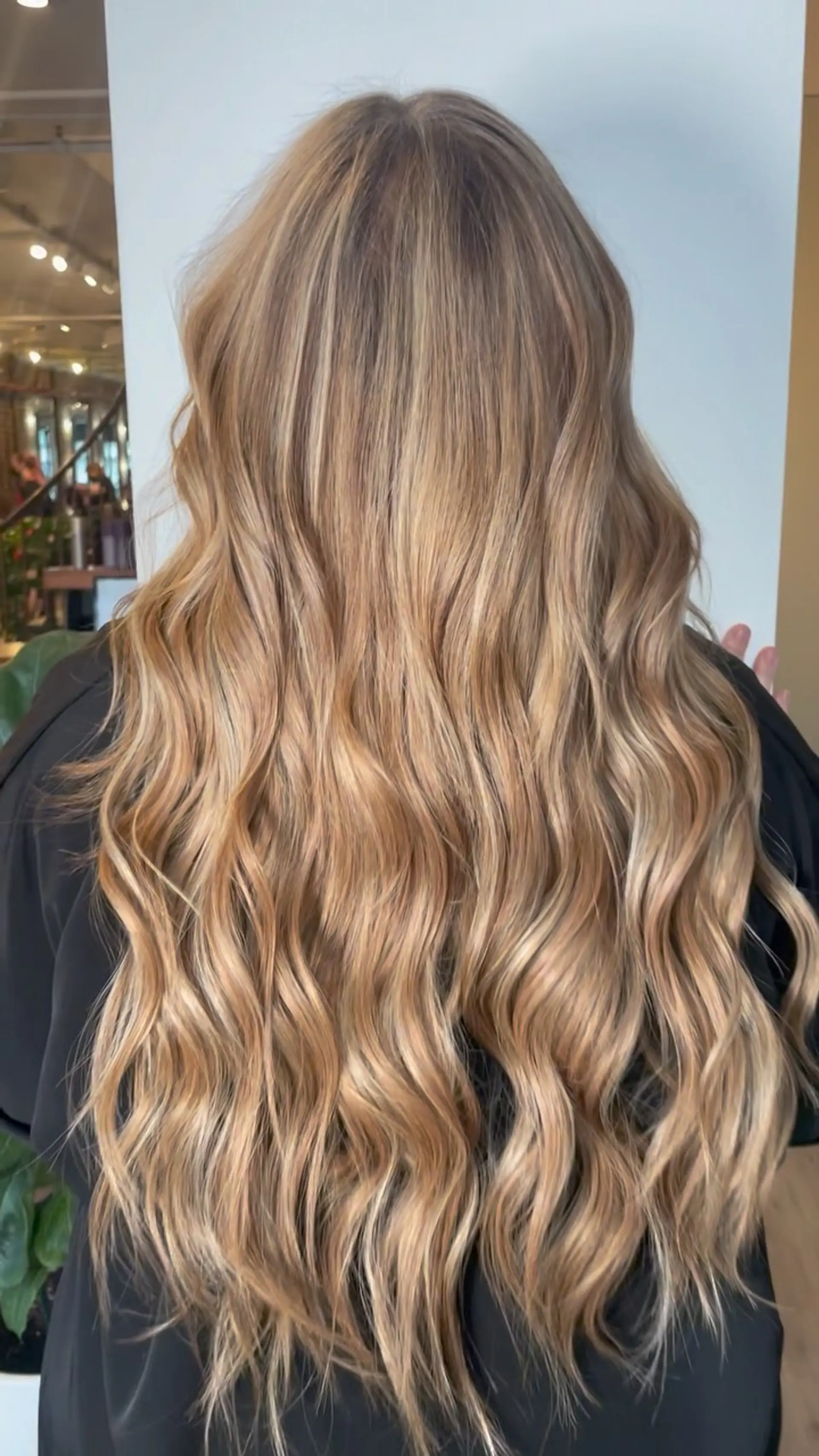Long, flowing warm blonde hair styled with soft, textured waves. 1