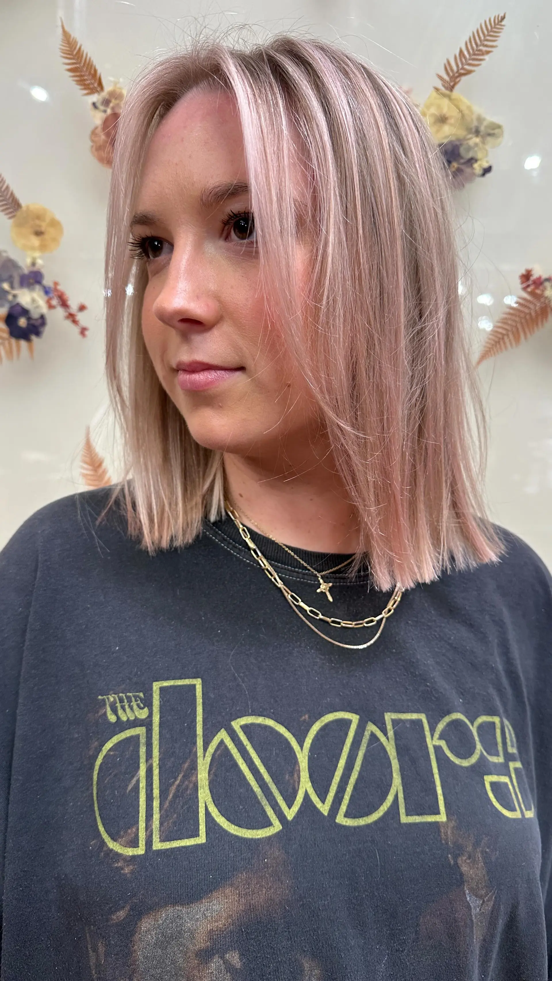 A blunt collarbone-length midi bob styled straight with soft face-framing pieces and a subtle pastel blush hue. 1