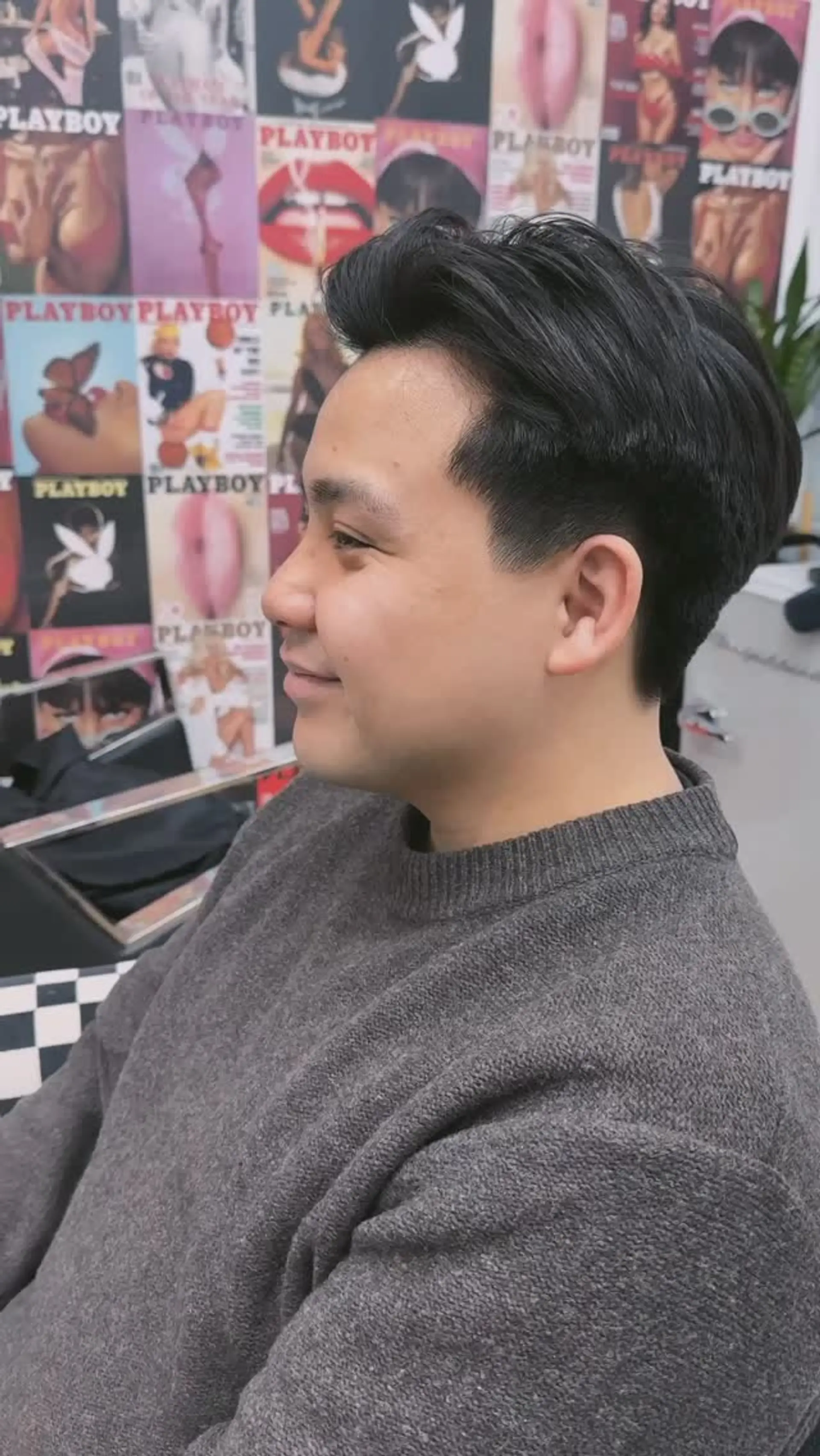 A clean scissor-cut men's style with softly tapered sides and textured volume swept back on top. 1