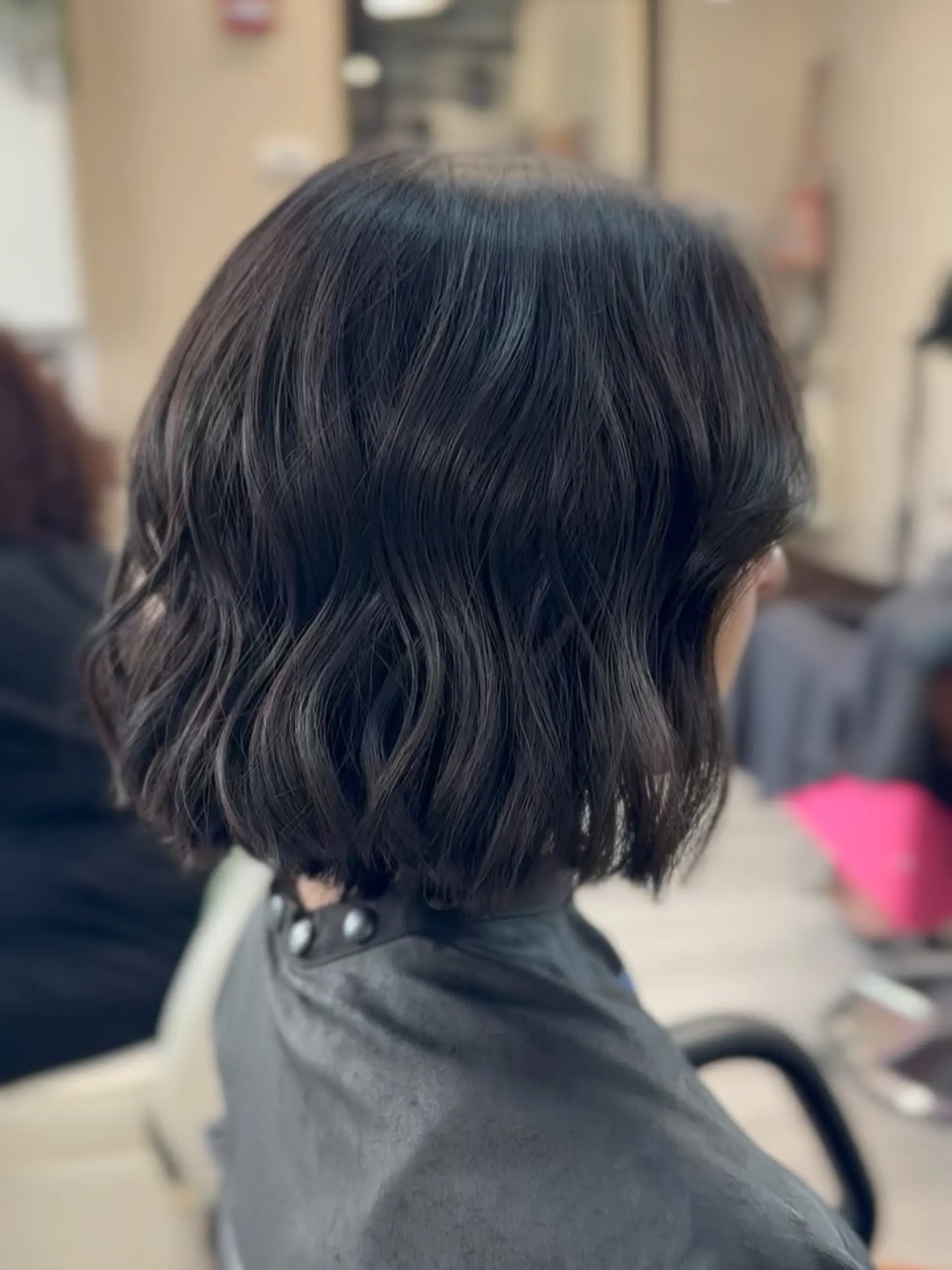 A chic chin-length textured bob styled with loose, relaxed waves. 1