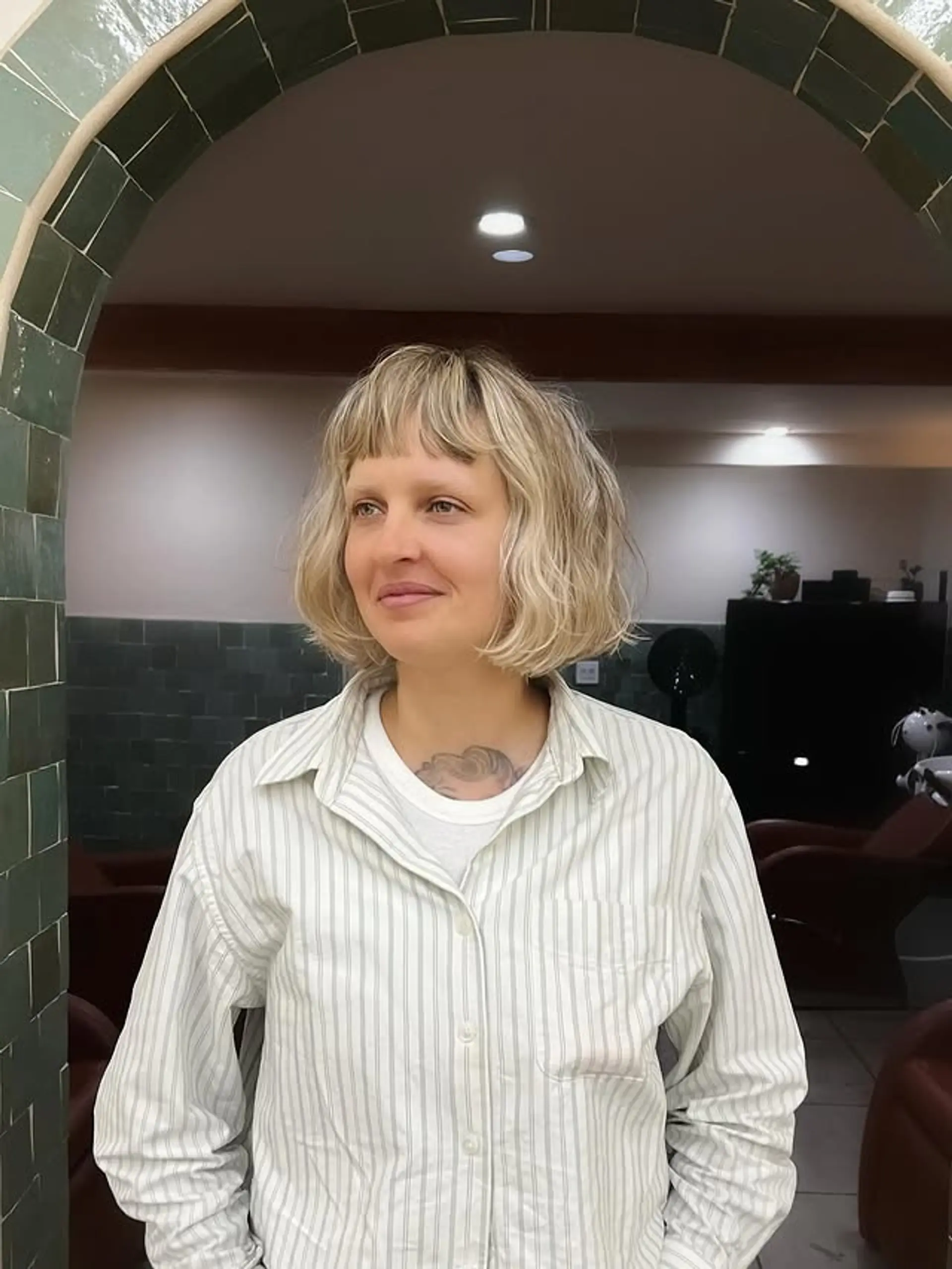 A trendy wavy bob with blunt bangs and textured layers. 1