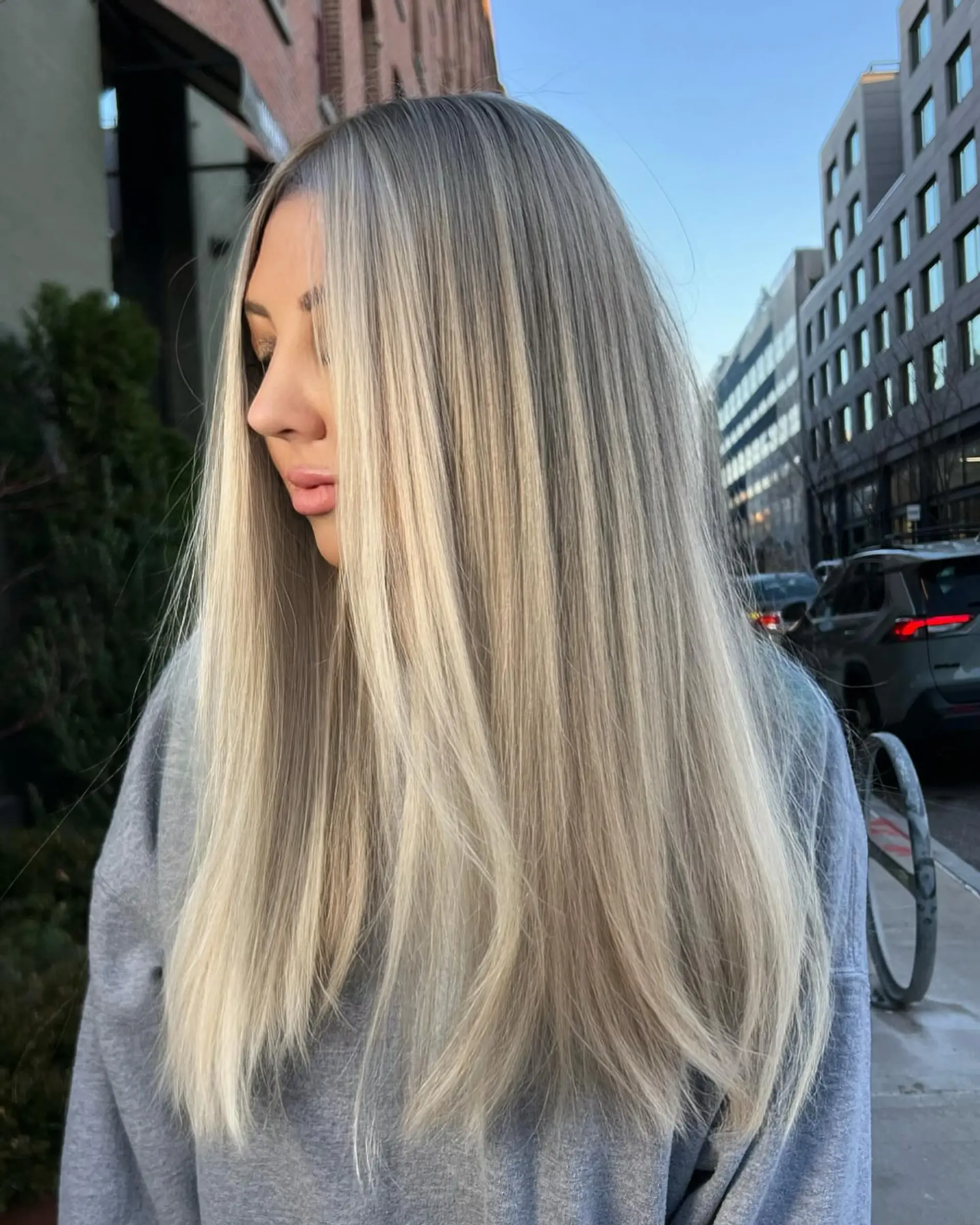 A long, straight sombre hairstyle with icy blonde coloring. 1