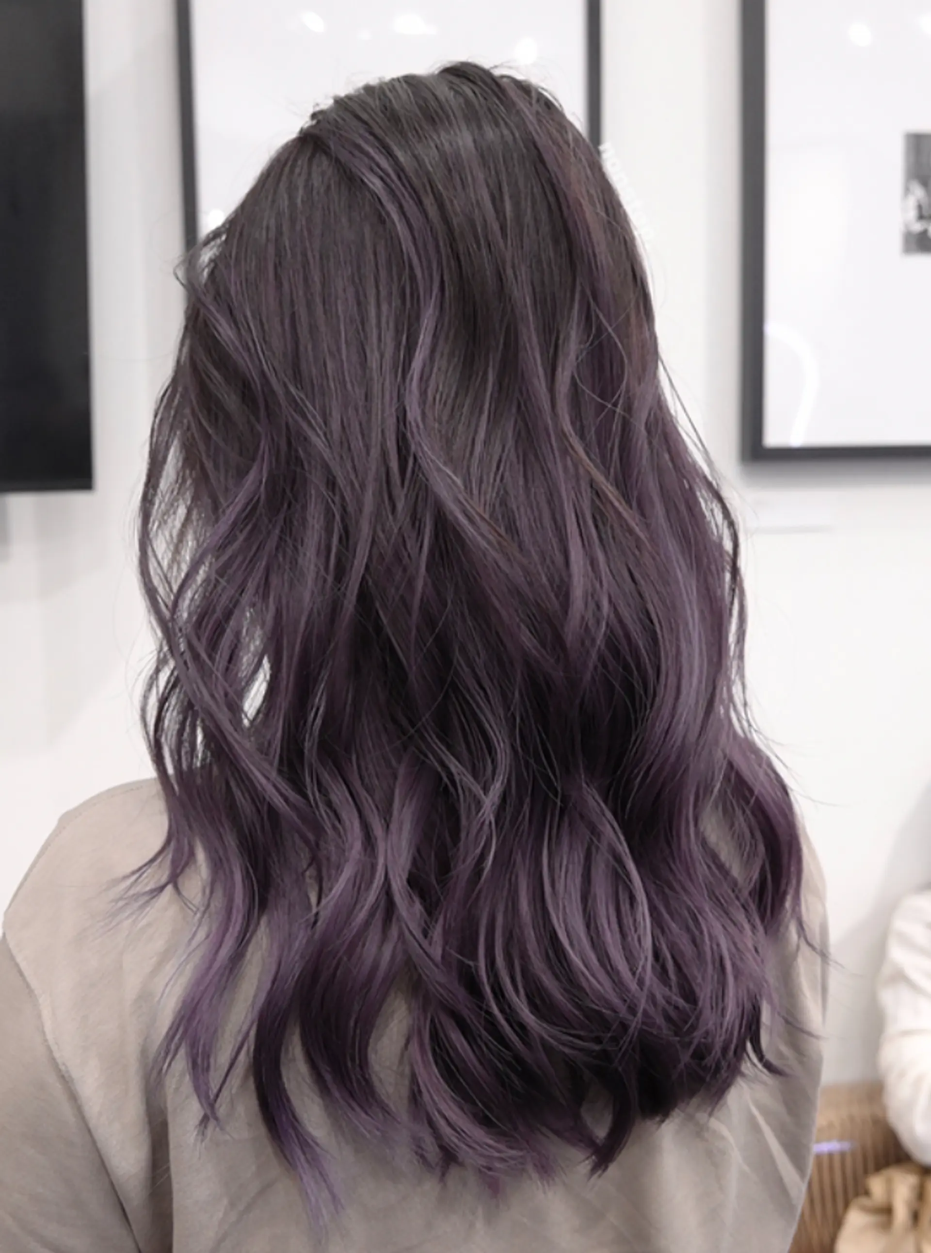 Long, wavy hair with an ombre balayage transitioning from black roots to purple ends, and layered for volume and movement. 2